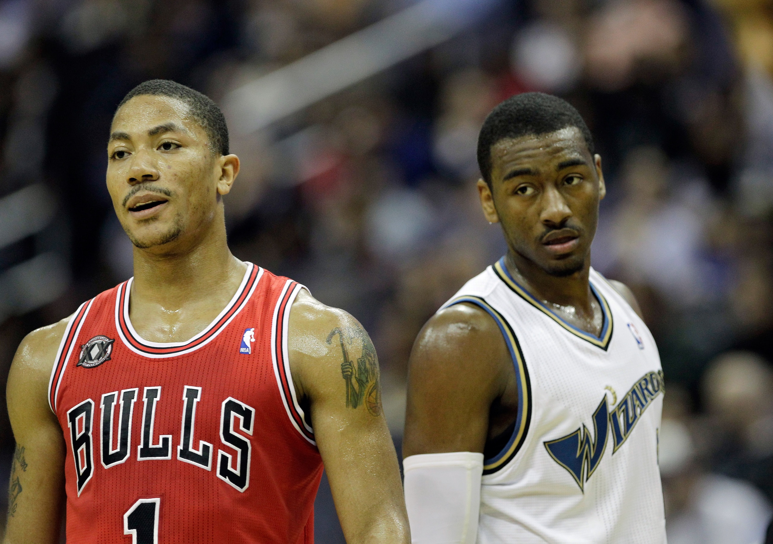 WASHINGTON, DC - FEBRUARY 28: John Wall #2 of the Washington Wizards (R) and Derrick Rose #1 of the Chicago Bulls (L) watch a foul shot at the Verizon Center in Washington on February 28, 2011 in Washington, DC. NOTE TO USER: User expressly acknowledges a