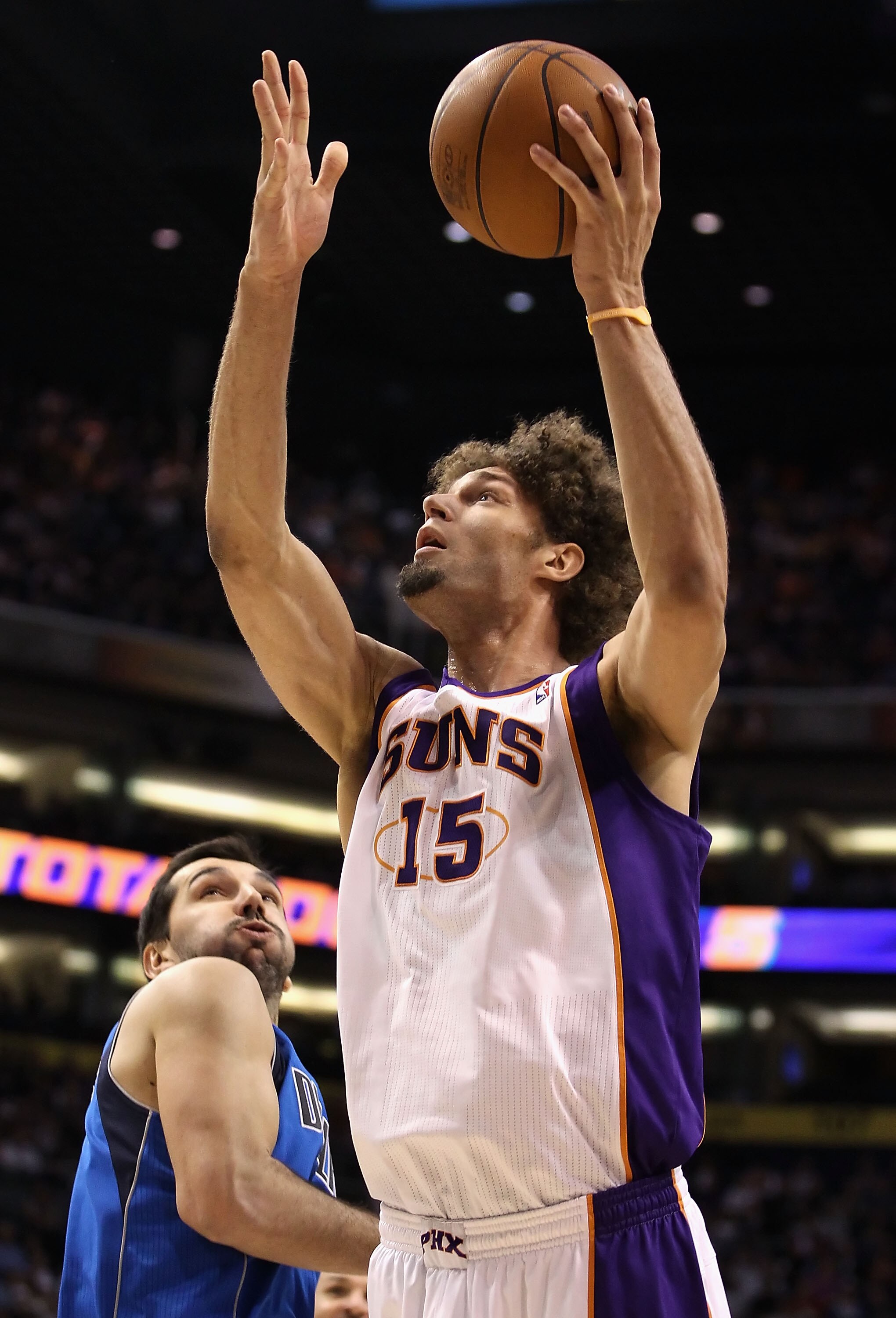 PHOENIX, AZ - FEBRUARY 17:  Robin Lopez #15 of the Phoenix Suns puts up a shot past Peja Stojakovic #16 of the Dallas Mavericks during the NBA game at US Airways Center on February 17, 2011 in Phoenix, Arizona.  NOTE TO USER: User expressly acknowledges a