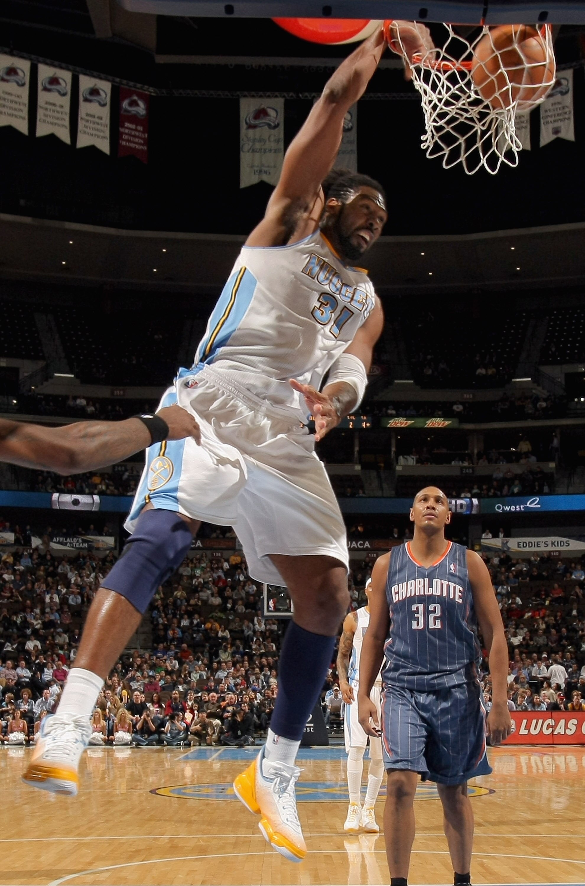 DENVER, CO - MARCH 02:  Nene #31 of the Denver Nuggets dunks the ball in front of Boris Diaw #32 of the Charlotte Bobcats at the Pepsi Center on March 2, 2011 in Denver, Colorado. The Nuggets defeated the Bobcats 120-80.NOTE TO USER: User expressly acknow