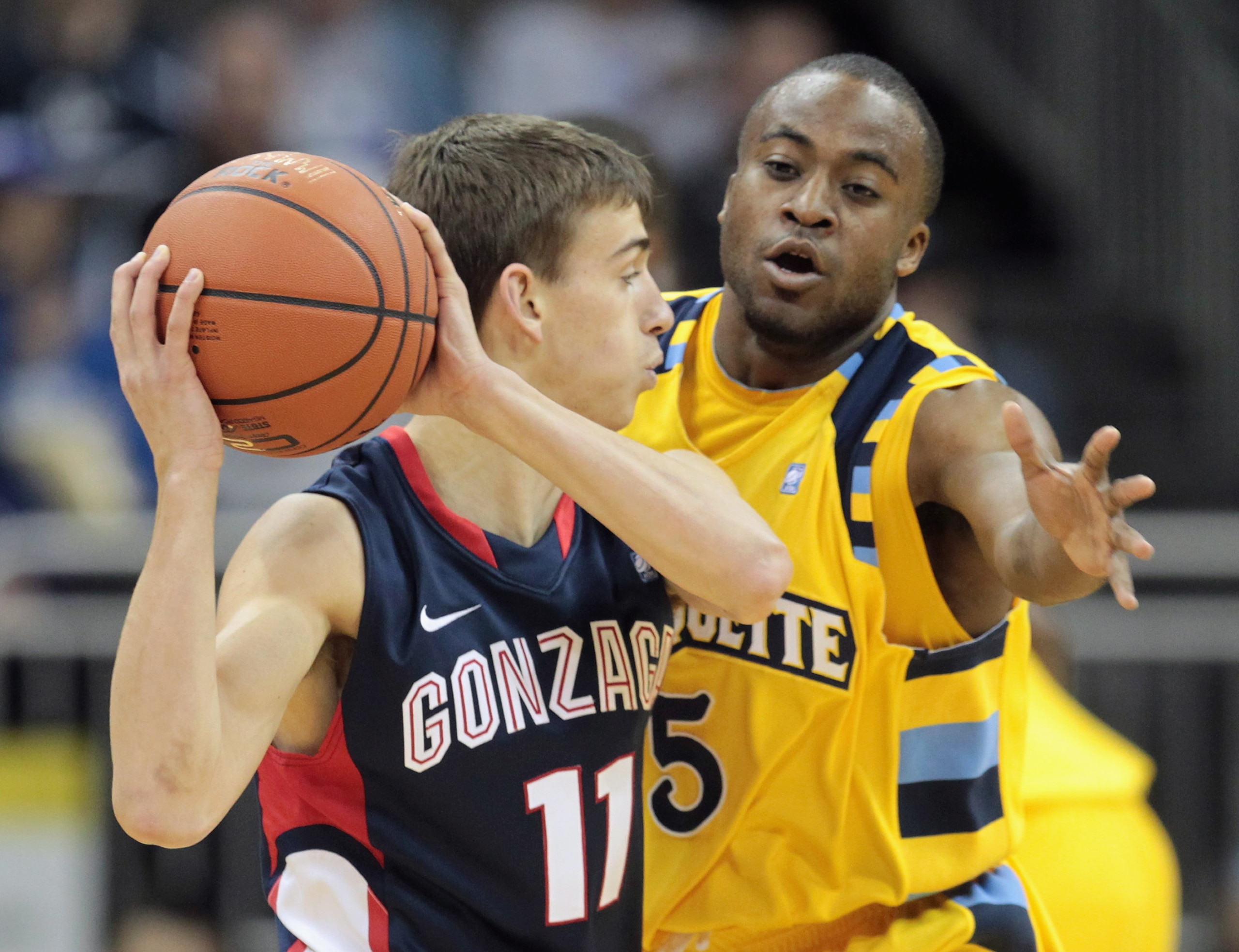 KANSAS CITY, MO - NOVEMBER 23:  David Stockton #11 of the Marquette Golden Eagles controls the ball as Junior Cadougan #5 of the Gonzaga Bulldogs defends during the CBE Classic consolation game on November 23, 2010 at the Sprint Center in Kansas City, Mis