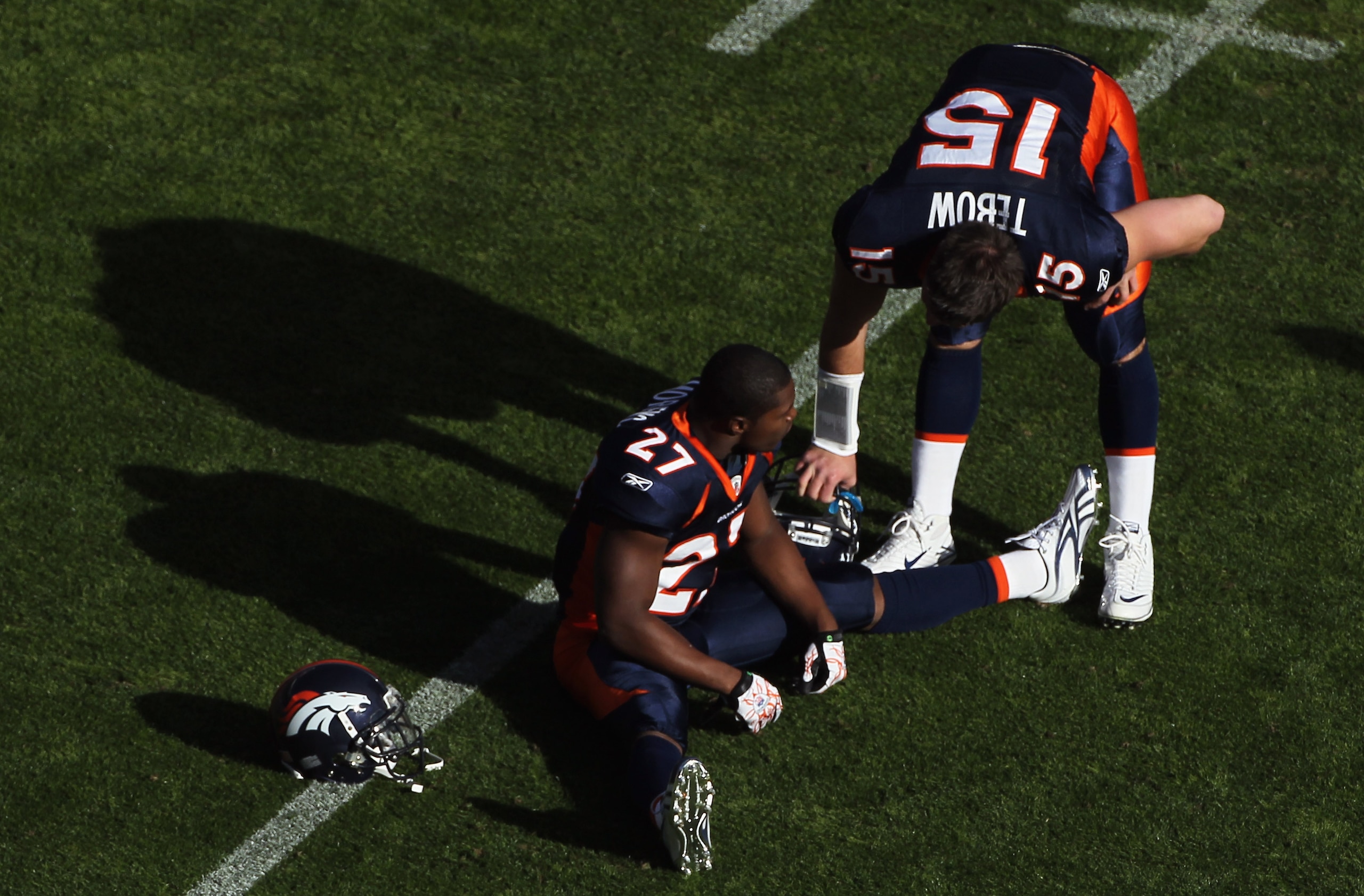 DENVER - DECEMBER 26:  Quarterback Tim Tebow #15 and running back Knowshon Moreno #27 of the Denver Broncos warm up prior to facing the Houston Texas at INVESCO Field at Mile High on December 26, 2010 in Denver, Colorado. The Broncos defeated the Texans 2