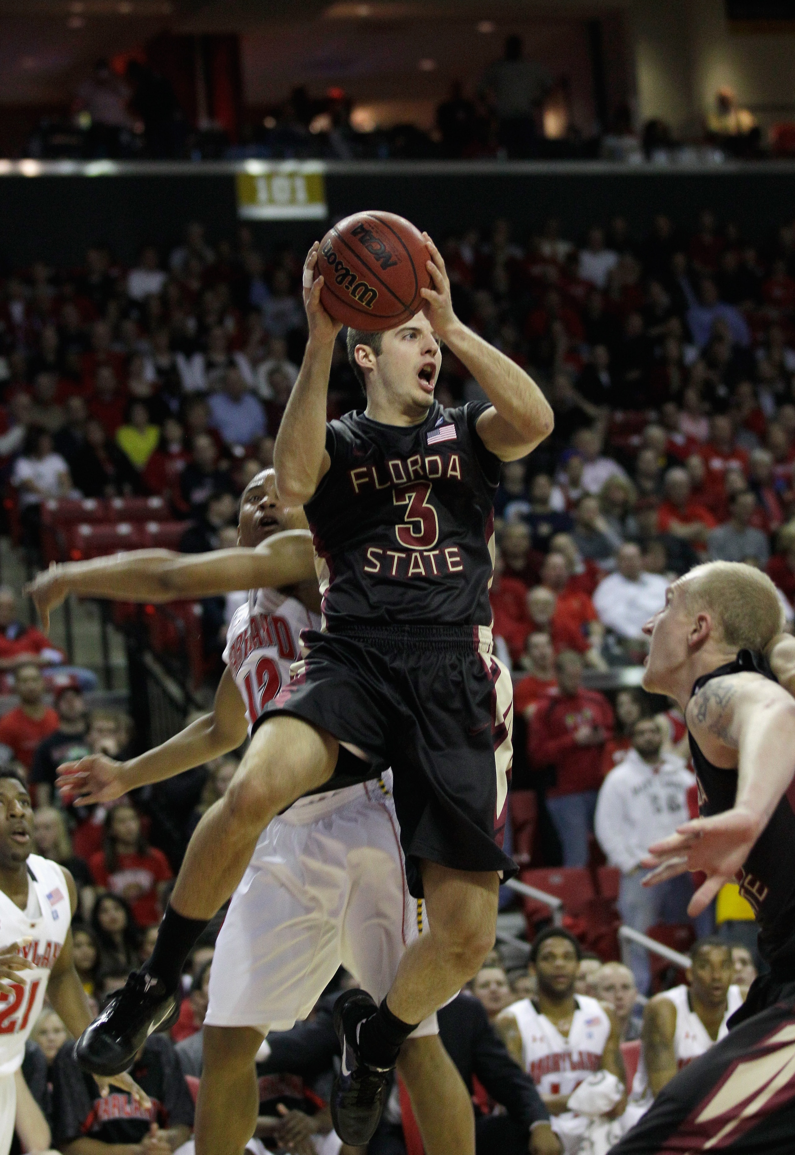 COLLEGE PARK, MD - FEBRUARY 23:  Luke Loucks #3 of the  Florida State Seminoles passes around Terrell Stoglin #12 of the  Maryland Terrapins at the Comast Center on February 23, 2011 in College Park, Maryland.  (Photo by Rob Carr/Getty Images)