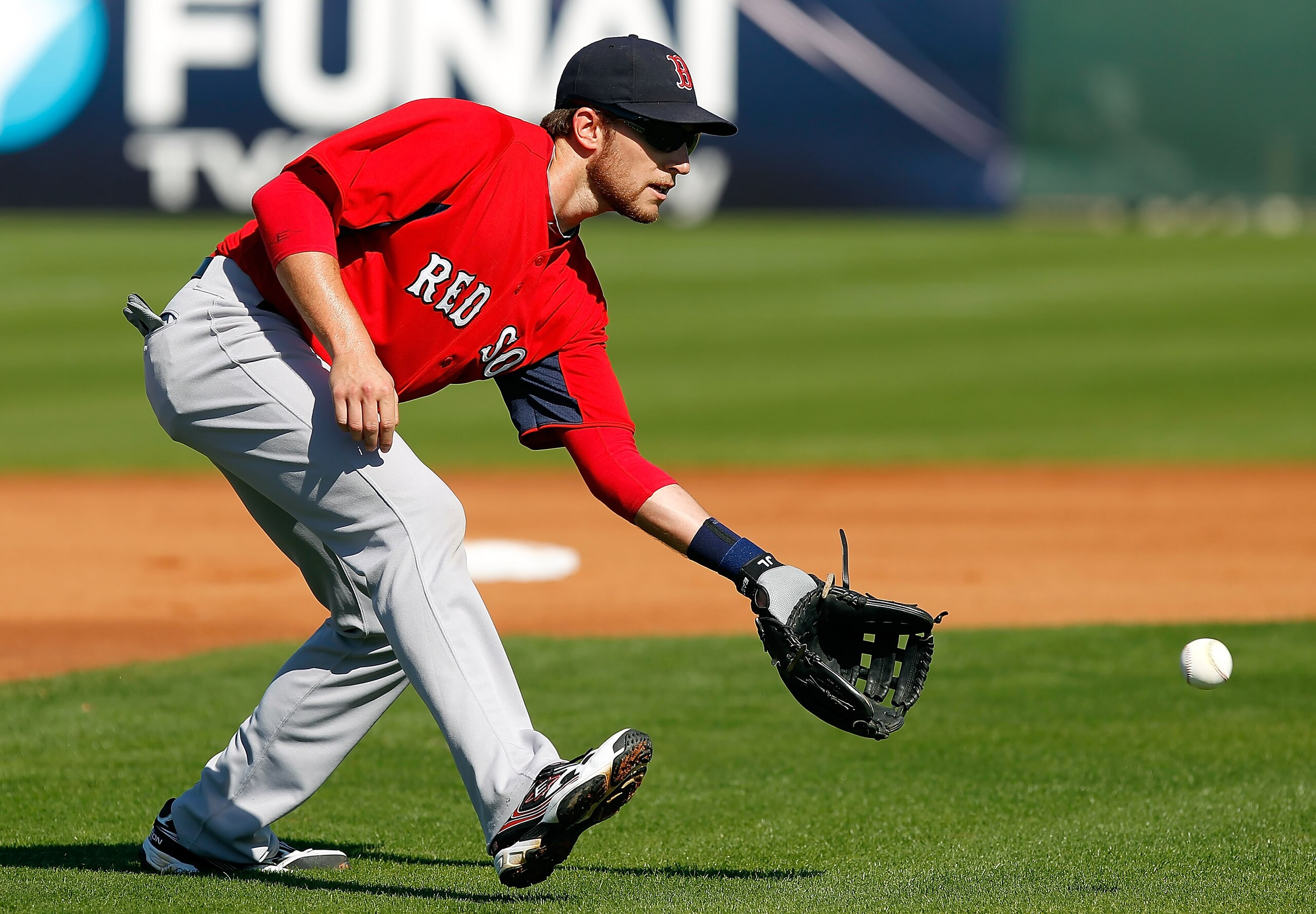 FORT MYERS, FL - FEBRUARY 19:  Infielder Jed Lowrie #12 of the Boston Red Sox fields a ground ball during a Spring Training Workout Session at the Red Sox Player Development Complex on February 19, 2011 in Fort Myers, Florida.  (Photo by J. Meric/Getty Im