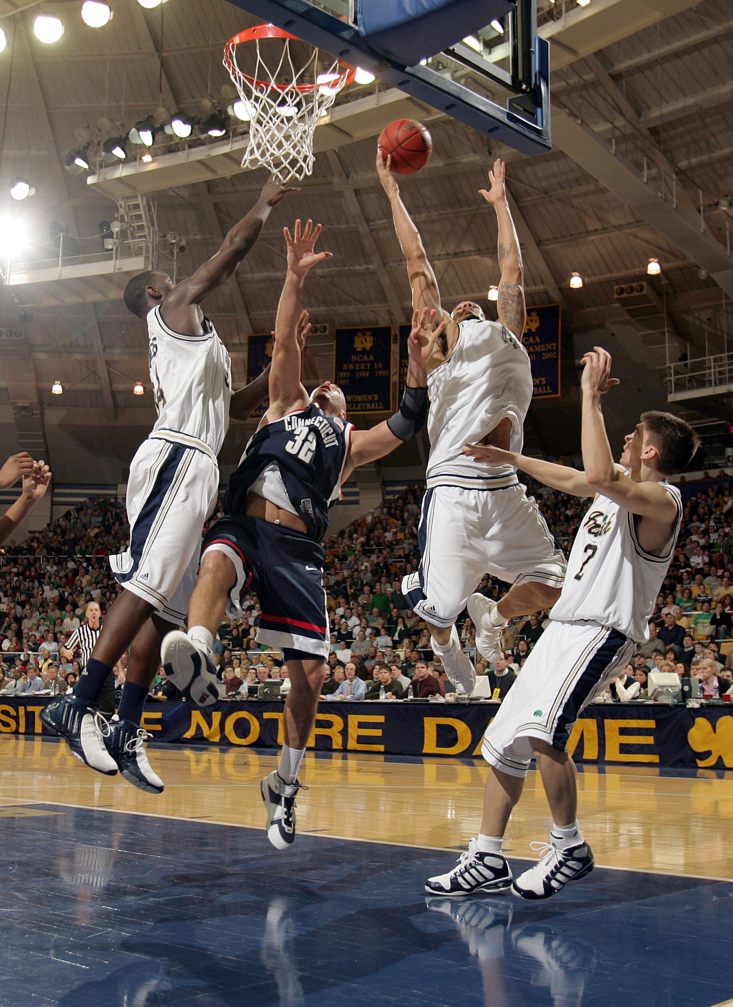 SOUTH BEND, IN - JANUARY 30:  Dennis Latimore #41 of the Notre Dame Fighting Irish battles Ed Nelson #32 of the Connecticut Huskies for a rebound as Torin Francis #34 (L) and Chris Quinn #2 defend on January 30, 2005 at the Joyce Center at University of N