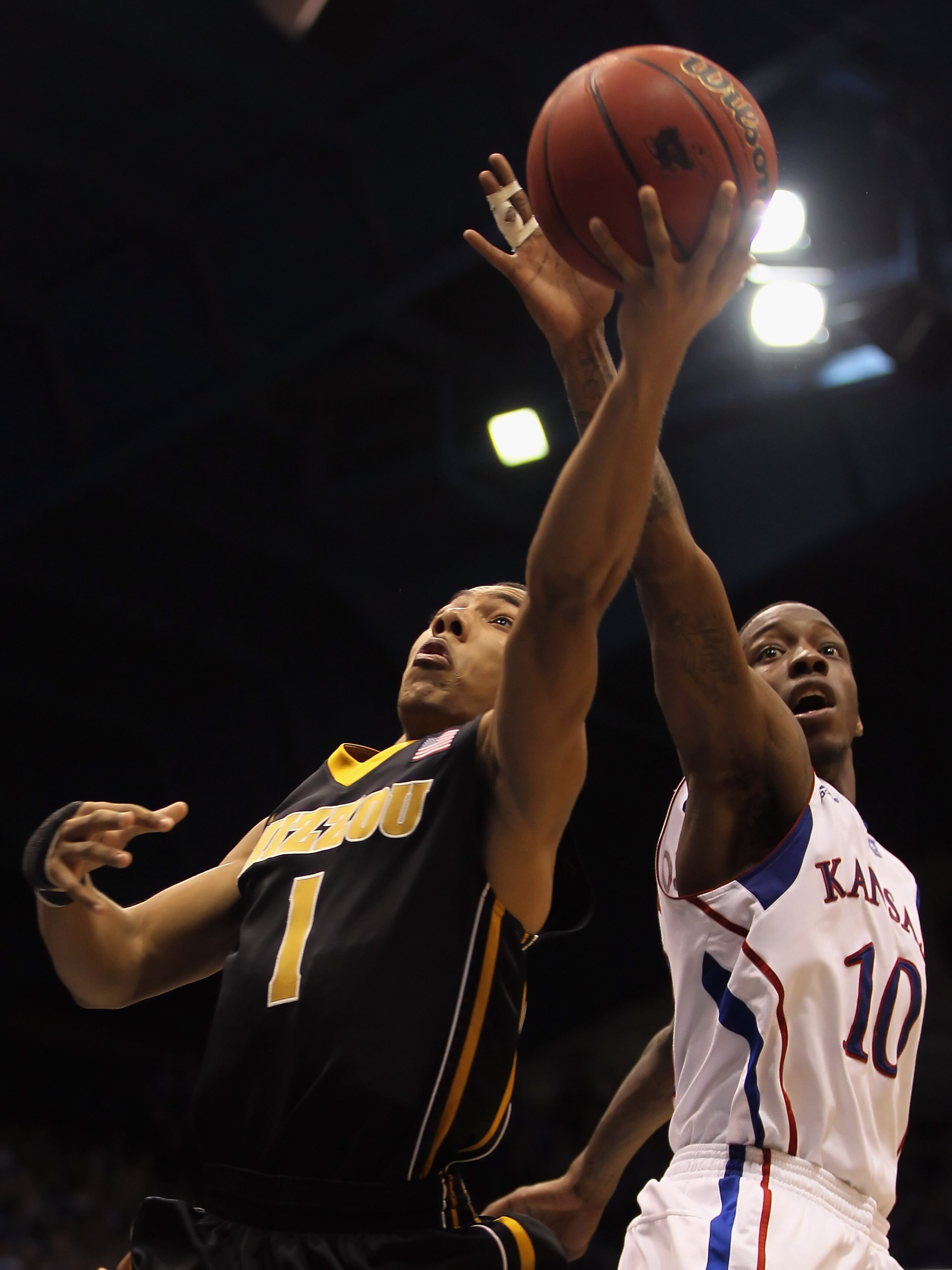 LAWRENCE, KS - FEBRUARY 07:  Phil Pressey #1 of the Missouri Tigers battles Tyshawn Taylor #10 of the Kansas Jayhawks for a rebound during the game on February 5, 2011 at Allen Fieldhouse in Lawrence, Kansas.  (Photo by Jamie Squire/Getty Images)