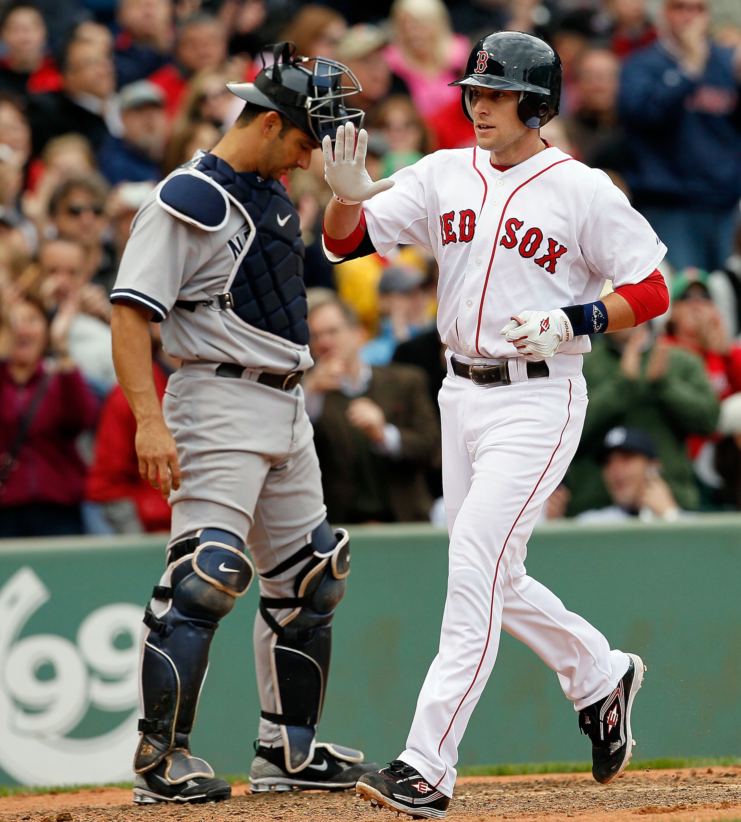 BOSTON - OCTOBER 3:  Jed Lowrie #12 of  the Boston Red Sox crosses home after hitting a home run against the New York Yankees at Fenway Park, October 3, 2010, in Boston, Massachusetts. (Photo by Jim Rogash/Getty Images)