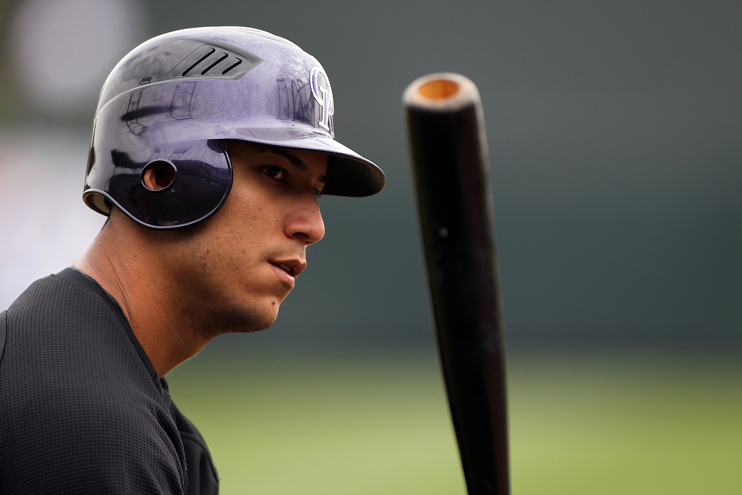 SCOTTSDALE, AZ - FEBRUARY 26:  Carlos Gonzalez #5 of the Colorado Rockies watches batting practice before the game against the Arizona Diamondbacks at Salt River Fields on February 26, 2011in Scottsdale, Arizona..  (Photo by Jonathan Ferrey/Getty Images)