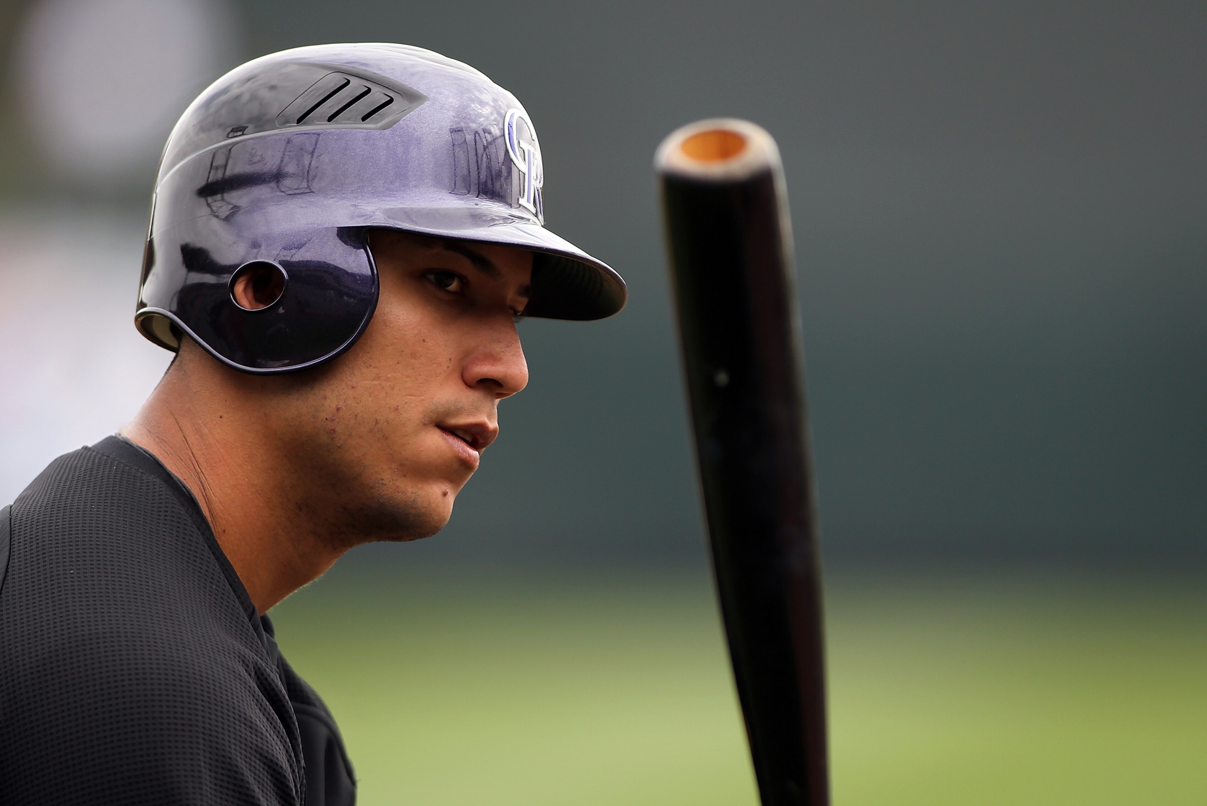 SCOTTSDALE, AZ - FEBRUARY 26:  Carlos Gonzalez #5 of the Colorado Rockies watches batting practice before the game against the Arizona Diamondbacks at Salt River Fields on February 26, 2011in Scottsdale, Arizona..  (Photo by Jonathan Ferrey/Getty Images)