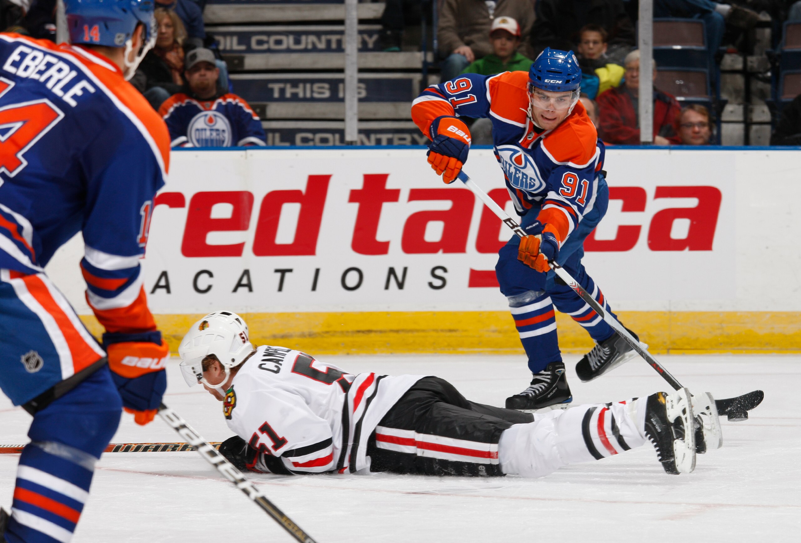 EDMONTON, CANADA - NOVEMBER 17: Magnus Paajarvi #91 of the Edmonton Oilers tries to flip a pass over to teammate Jordan Eberle #14 as Brian Campbell #51 of the Chicago Blackhawks breaks up the play  in third-period action.  Chicago won the game 5-0 at Rex