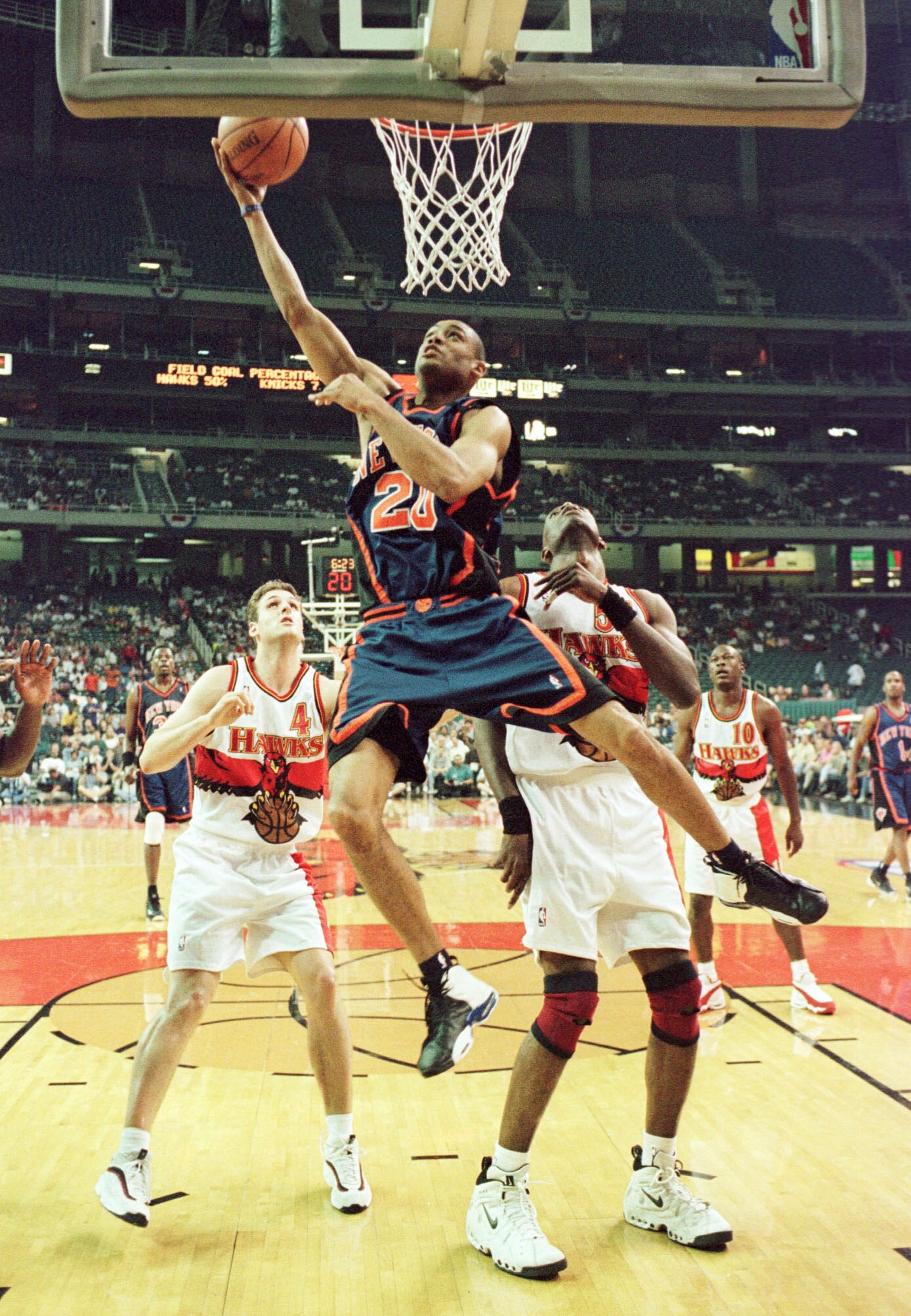 20 May 1999:  Allan Houston #20 of the New York Knicks soars to the basket against Chris Crawford #4 and Dikembe Mutombo #55 of the Atlanta Hawks during game 2 of the NBA Eastern Conference semifinals at the Georgia Dome in Atlanta, Georgia. Mandatory Cre