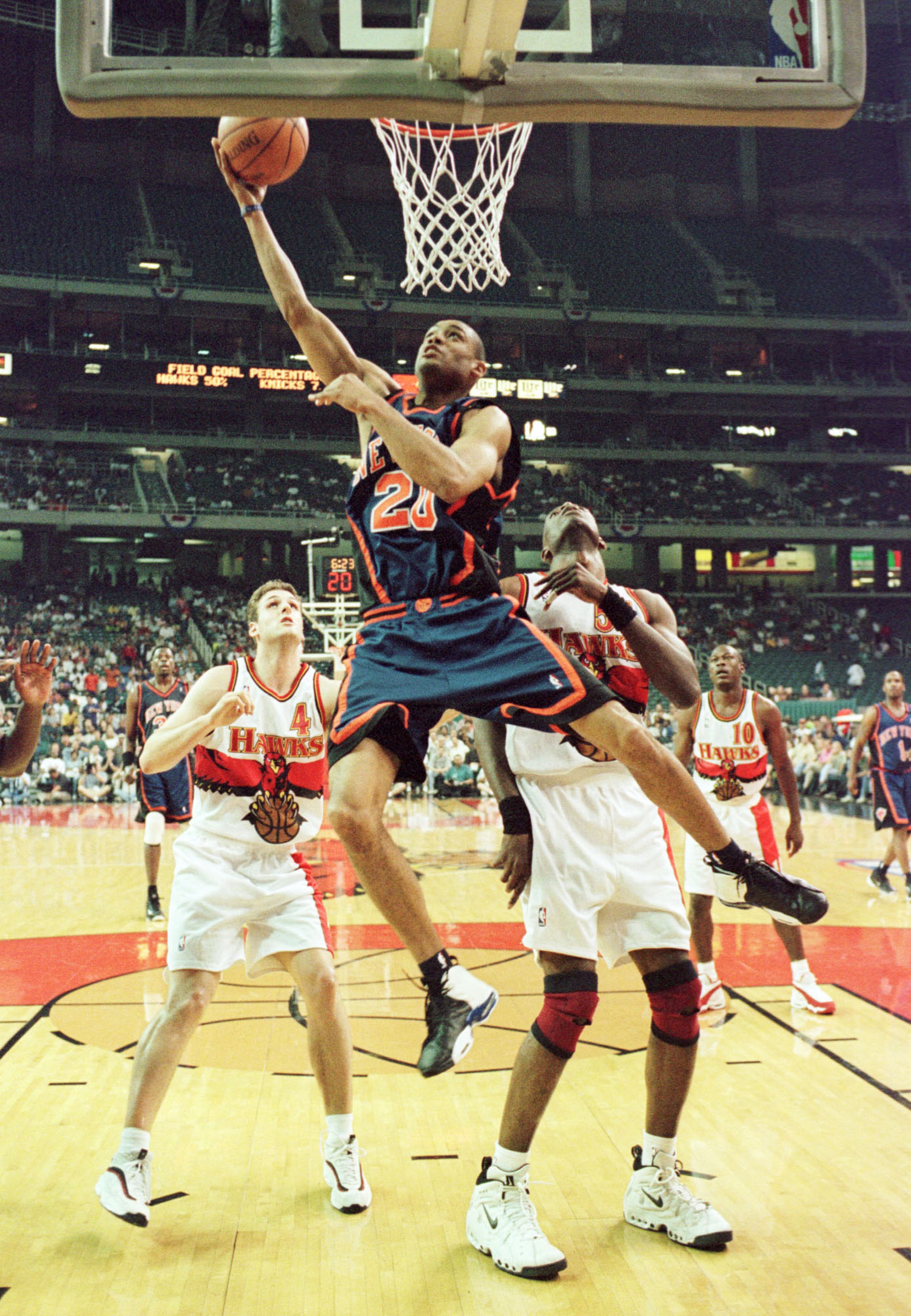 20 May 1999: Allan Houston #20 of the New York Knicks soars to the basket against Chris Crawford #4 and Dikembe Mutombo #55 of the Atlanta Hawks during game 2 of the NBA Eastern Conference semifinals at the Georgia Dome in Atlanta, Georgia. Mandatory Cre 20 May 1999: Allan Houston #20 of the New York Knicks soars to the basket against Chris Crawford #4 and Dikembe Mutombo #55 of the Atlanta Hawks during game 2 of the NBA Eastern Conference semifinals at the Georgia Dome in Atlanta, Georgia. Mandatory Cre