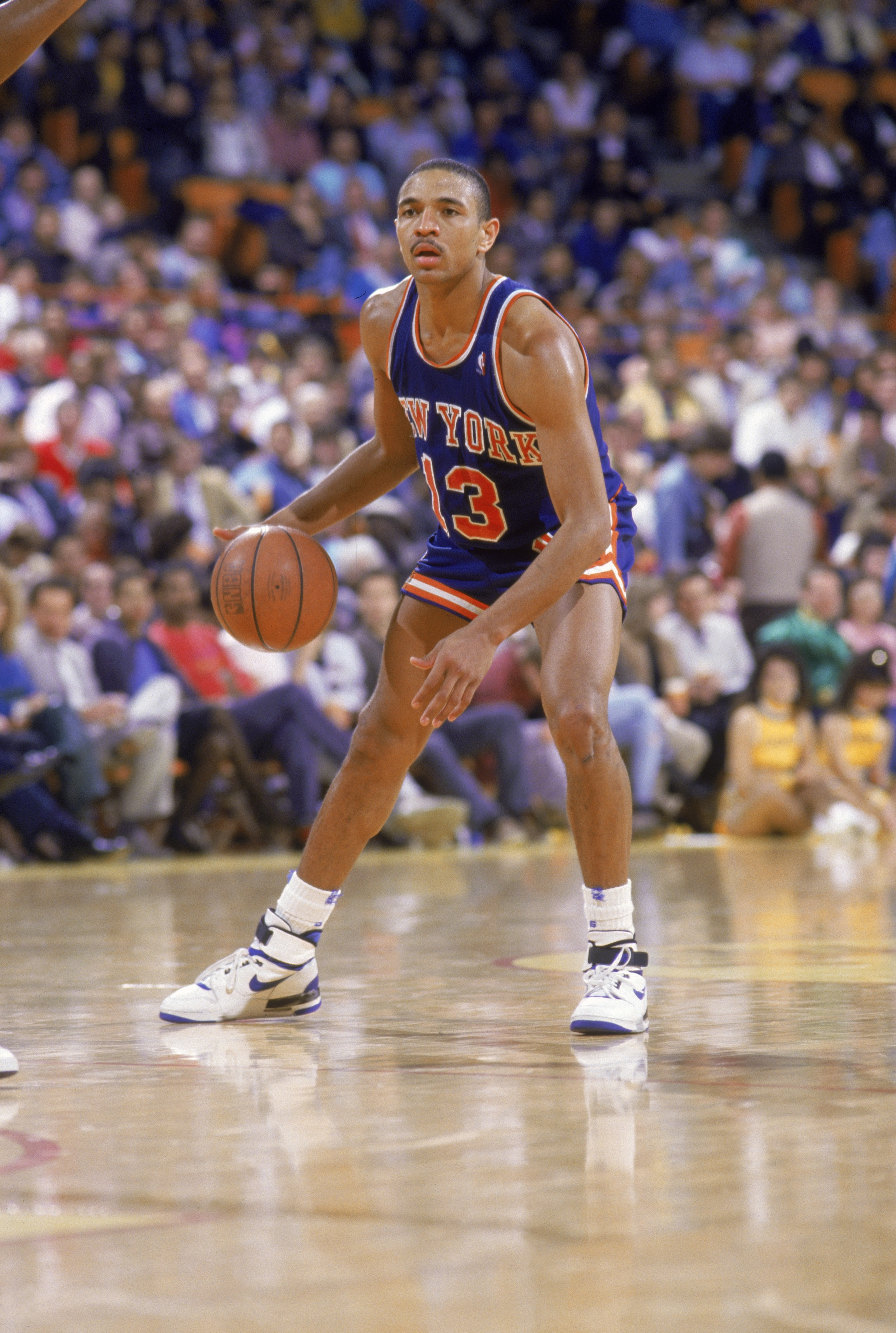 LOS ANGELES - 1987:  Mark Jackson #13 of the New York Knicks stand on the sideline as the crowd celebrates during an NBA game against the Los Angeles Lakers at the Great Western Forum in Los Angeles, California in 1987.  (Photo by: Stephen Dunn/Getty Imag