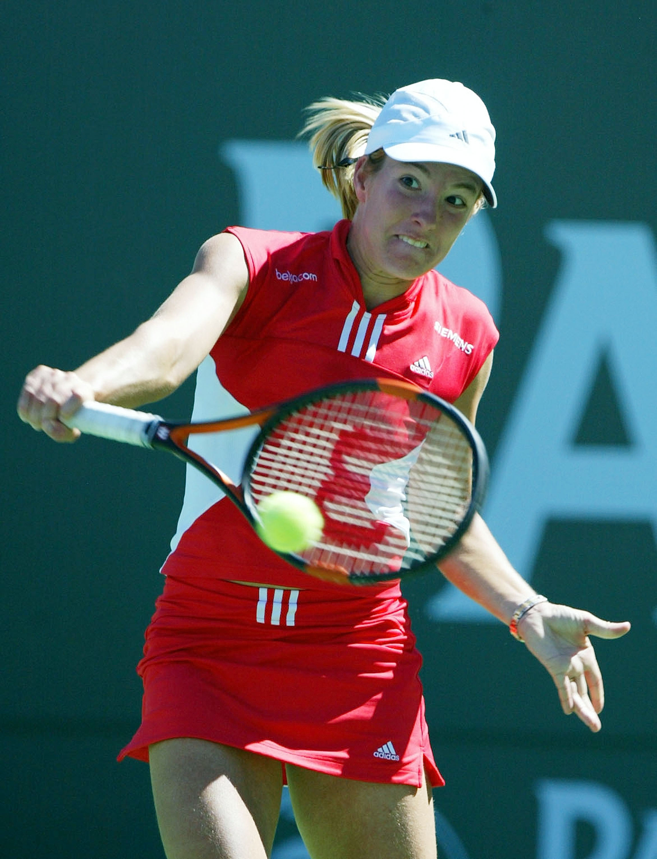 INDIAN WELLS, CA - MARCH 21:  Justine Henin-Hardenne of Belgium returns the ball before defeating Lindsay Davenport of the U.S. during the Women's Final match by a score of 6-1, 6-4 at the Pacific Life Open on March 21, 2004 at the Indian Wells Tennis Gar