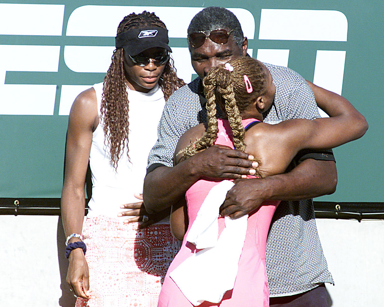 17 Mar 2001:  Serena Williams of the USA hugs her father Richard as her sister Venus waits in the back after her victory over Kim Clijsters of Belgium during the final of the Tennis Masters Series at Indian Wells, California. <DIGITAL IMAGE> Mandatory Cre