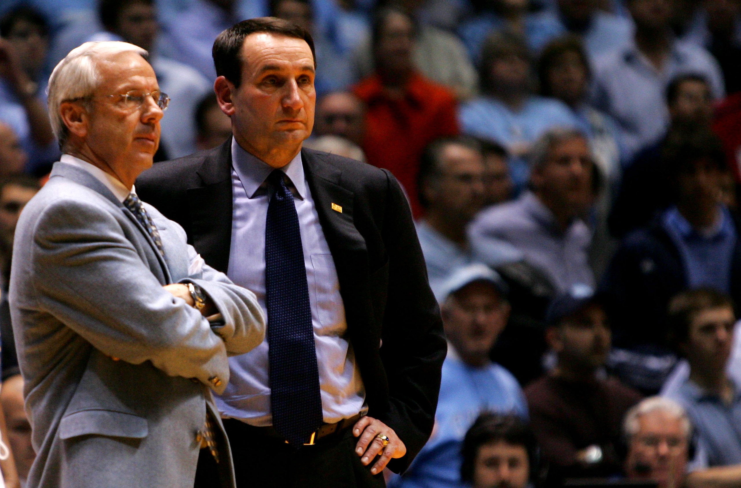 CHAPEL HILL, NC - MARCH 04:  Head coach Mike Krzyzewski (R) of the Duke Blue Devils waits on the officials with head coach Roy Williams of the University of North Carolina Tar Heels after an incident involving Tyler Hansbrough and Gerald Henderson during