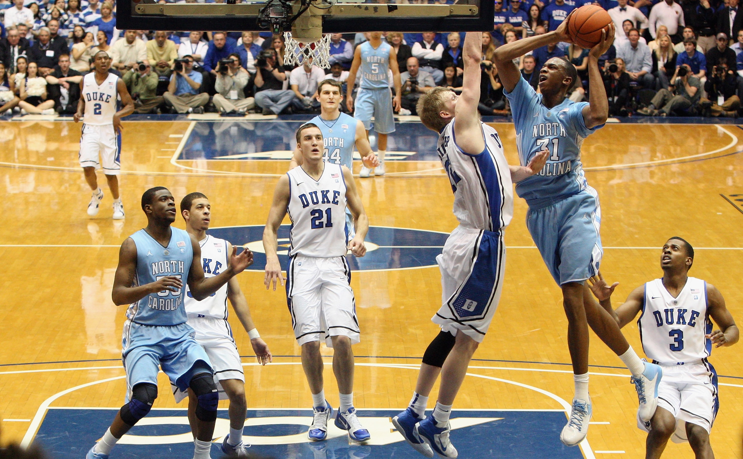 DURHAM, NC - FEBRUARY 09:  John Henson #31 of the North Carolina Tar Heels drives to the basket against Kyle Singler #12 of the Duke Blue Devils during their game at Cameron Indoor Stadium on February 9, 2011 in Durham, North Carolina.  (Photo by Streeter