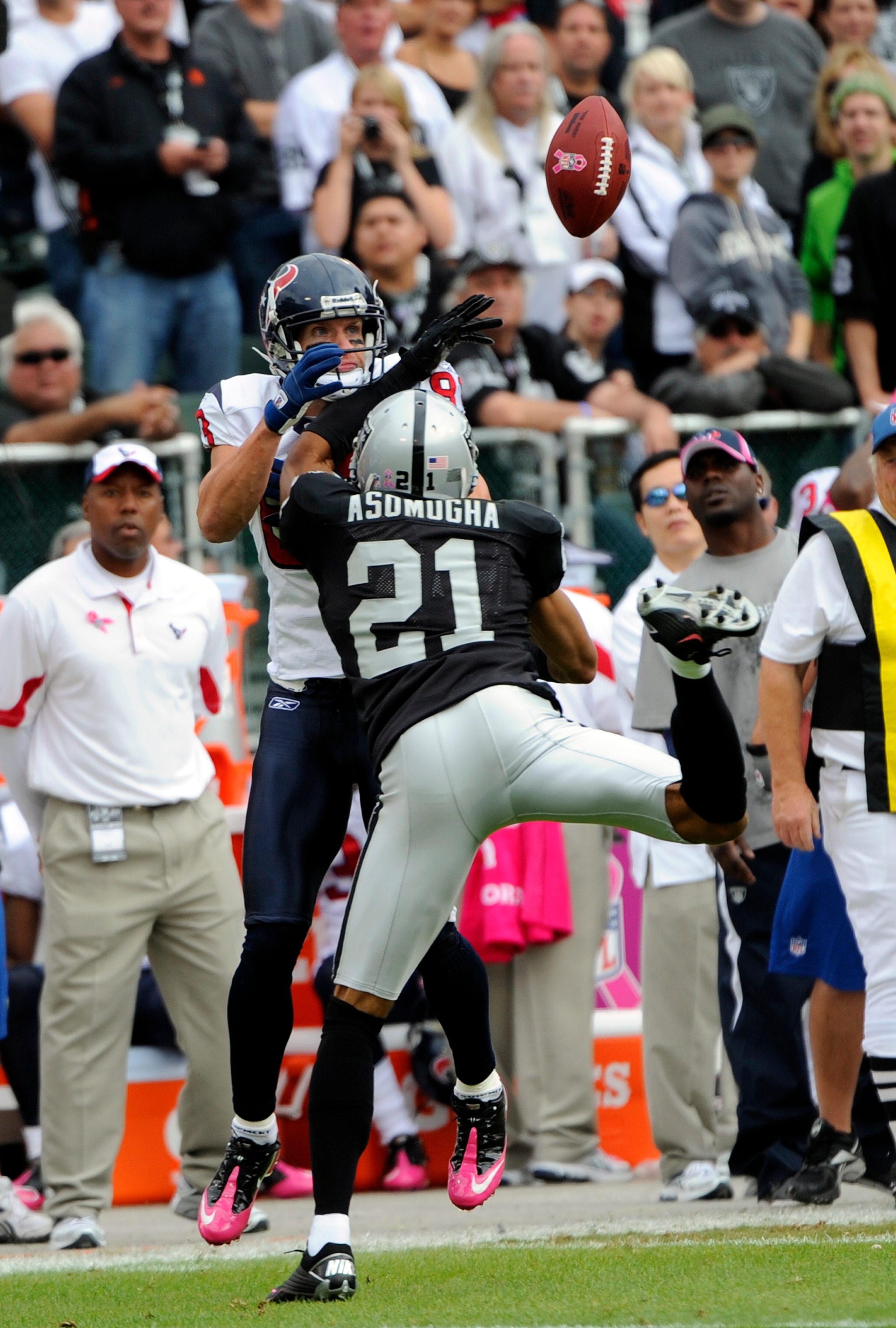 OAKLAND, CA - OCTOBER 3:  Defensive back Nnamdi Asomugha #21 of the Oakland Raiders breaks up a pass to wide receiver Kevin Walter #83 of the Houston Texans during an NFL football game October 3, 2010 at The Oakland-Alameda County Coliseum in Oakland, Cal