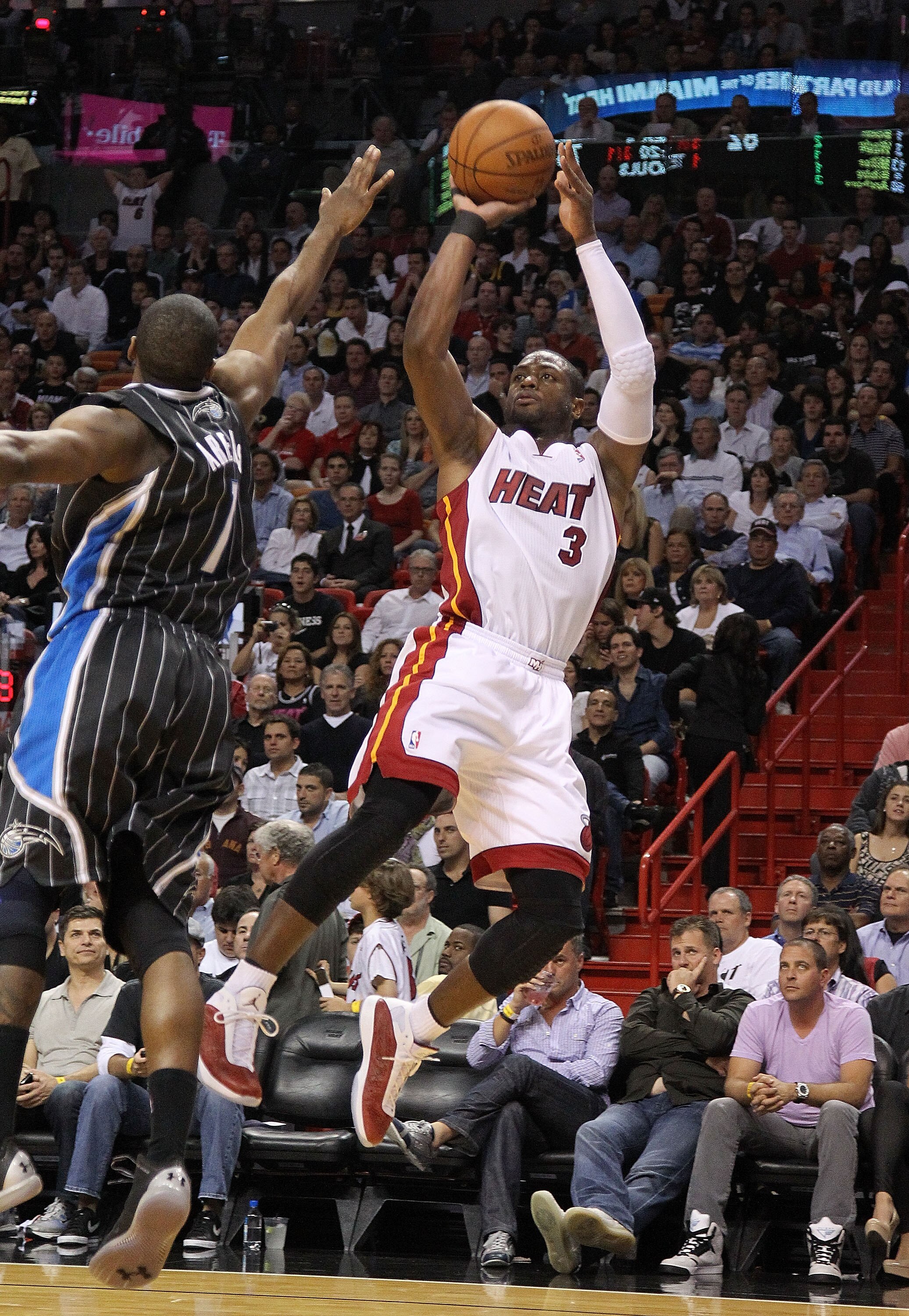 MIAMI, FL - MARCH 03:  Dwyane Wade #3 of the Miami Heat shoots over Gilbert Arenas #1 of the Orlando Magic during a game at American Airlines Arena on March 3, 2011 in Miami, Florida. NOTE TO USER: User expressly acknowledges and agrees that, by downloadi