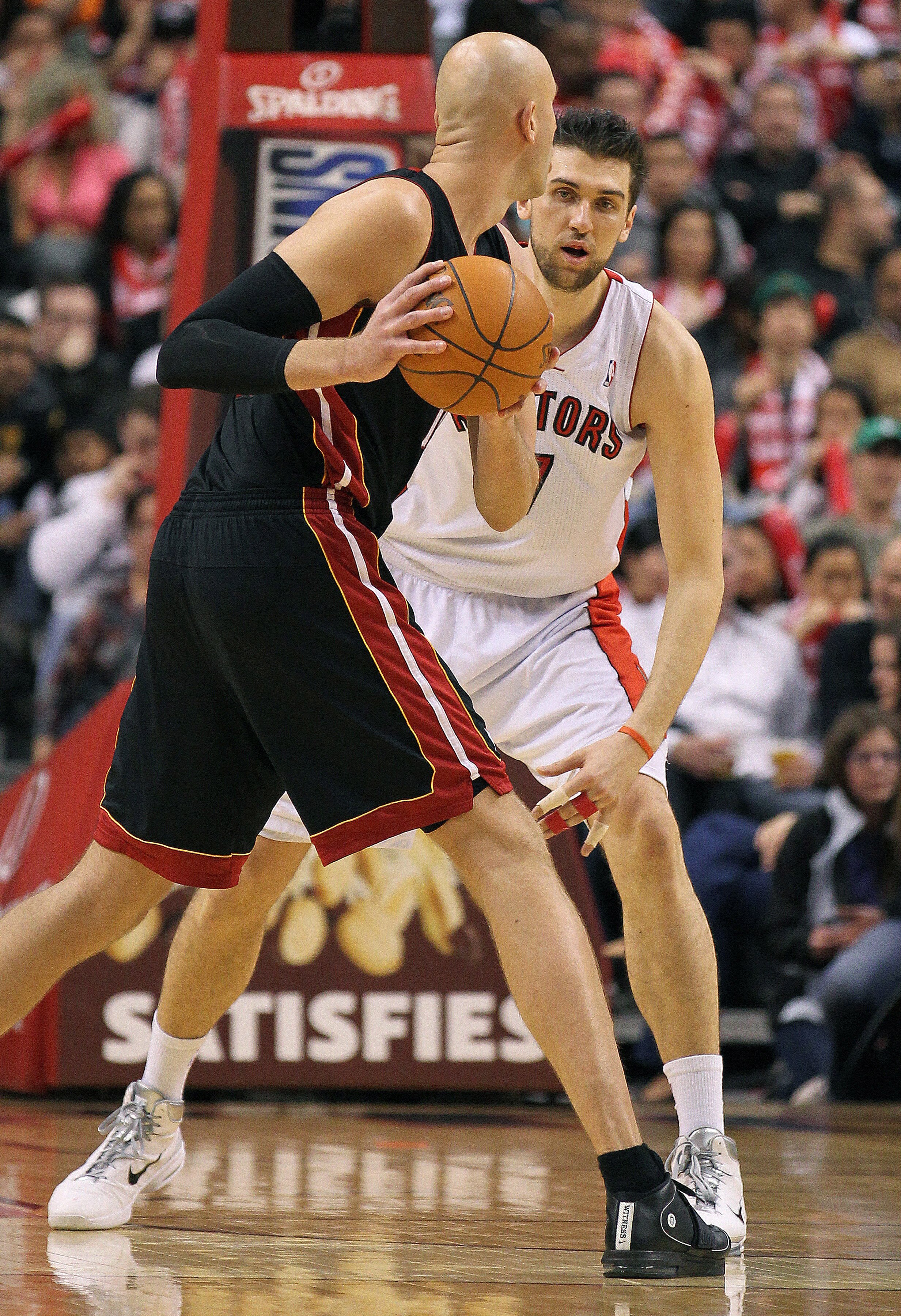 TORONTO, CANADA - FEBRUARY 16:  Zydrunas IIgauskas #11 of the Miami Heat gets set to make a play around Andrea Bargnani #7 of the Toronto Raptors in a game on February 16, 2011 at the Air Canada Centre in Toronto, Canada. The Heat defeated the Raptors 103