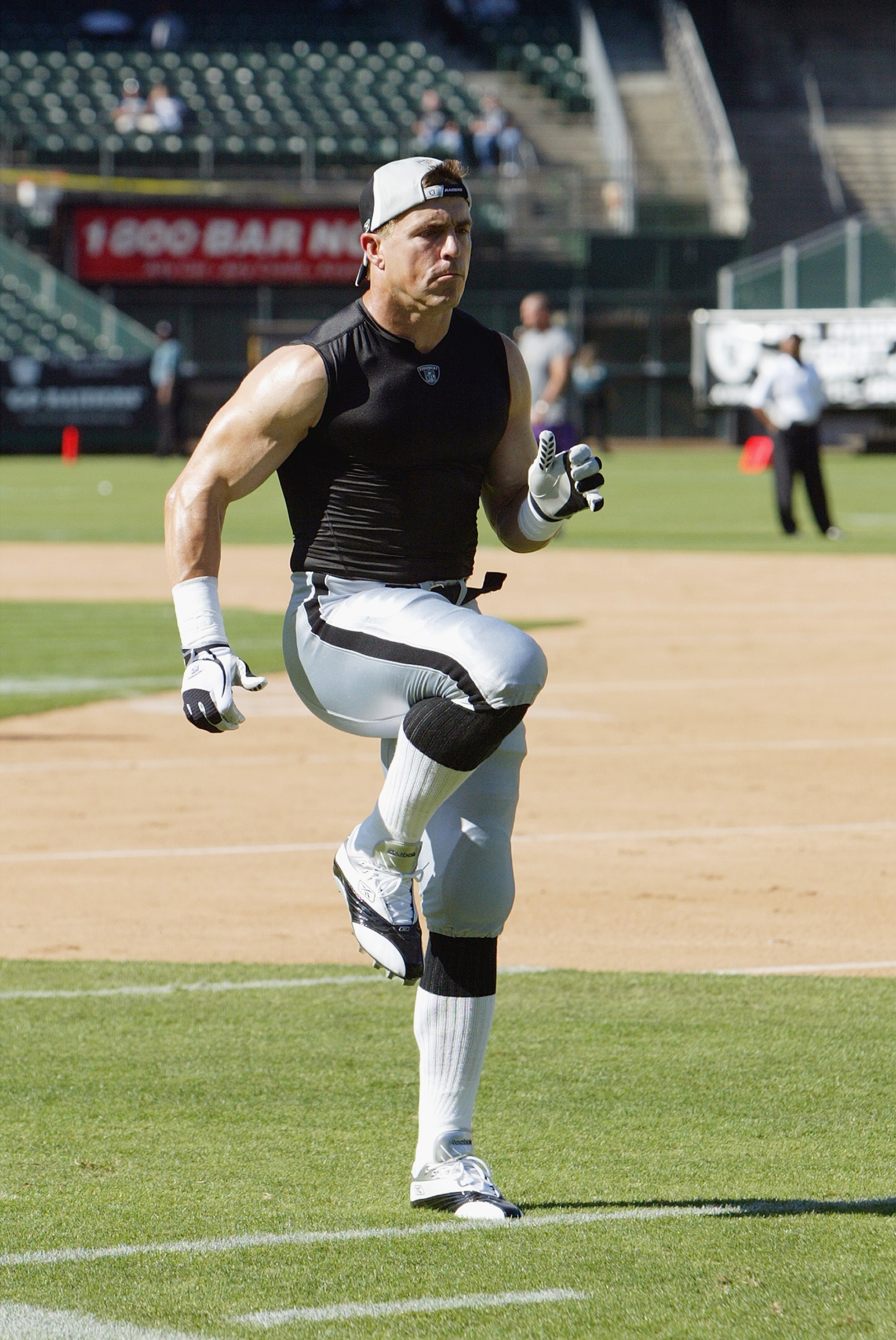 OAKLAND, CA - AUGUST 22 :  Bill Romanowski #53 of the Oakland Raiders warms up before the game against the Minnesota Vikings on August 22, 2003 at the Network Associates Coliseum in Oakland, California.  The Vikings defeated the Raiders 21-6.  (Photo by J