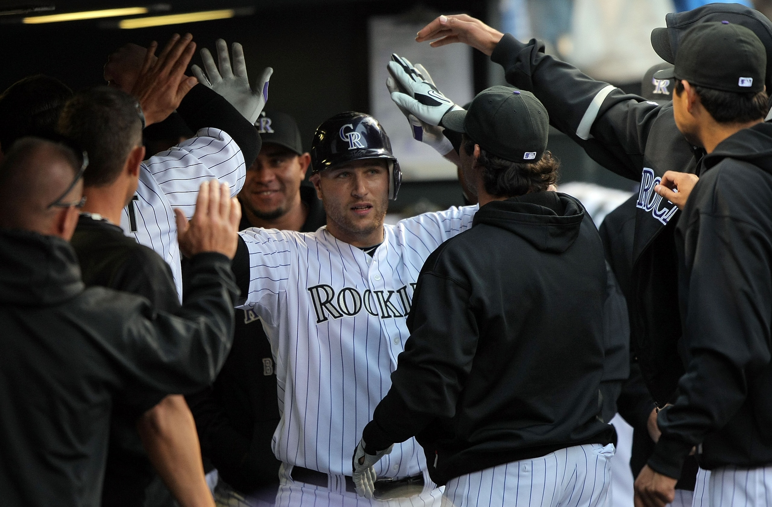 DENVER - APRIL 10: Catcher Chris Iannetta #20 of the Colorado Rockies is welcomed back to the dugout after his third inning solo homerun against the San Diego Padres during MLB action at Coors Field on April 10, 2010 in Denver, Colorado. (Photo by Doug DENVER - APRIL 10: Catcher Chris Iannetta #20 of the Colorado Rockies is welcomed back to the dugout after his third inning solo homerun against the San Diego Padres during MLB action at Coors Field on April 10, 2010 in Denver, Colorado. (Photo by Doug