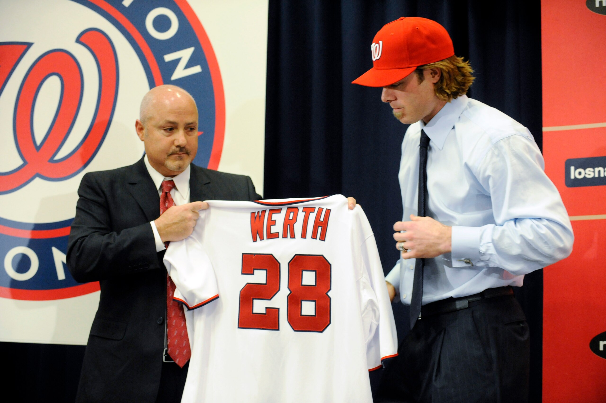 WASHINGTON, DC - DECEMBER 15: Executive Vice President of Baseball Operations and General Manager Mike Rizzo (L) holds up a jersey as he introduces Jayson Werth #28 to the media on December 15, 2010 at Nationals Park in Washington, DC. (Photo by Mitch WASHINGTON, DC - DECEMBER 15: Executive Vice President of Baseball Operations and General Manager Mike Rizzo (L) holds up a jersey as he introduces Jayson Werth #28 to the media on December 15, 2010 at Nationals Park in Washington, DC. (Photo by Mitch