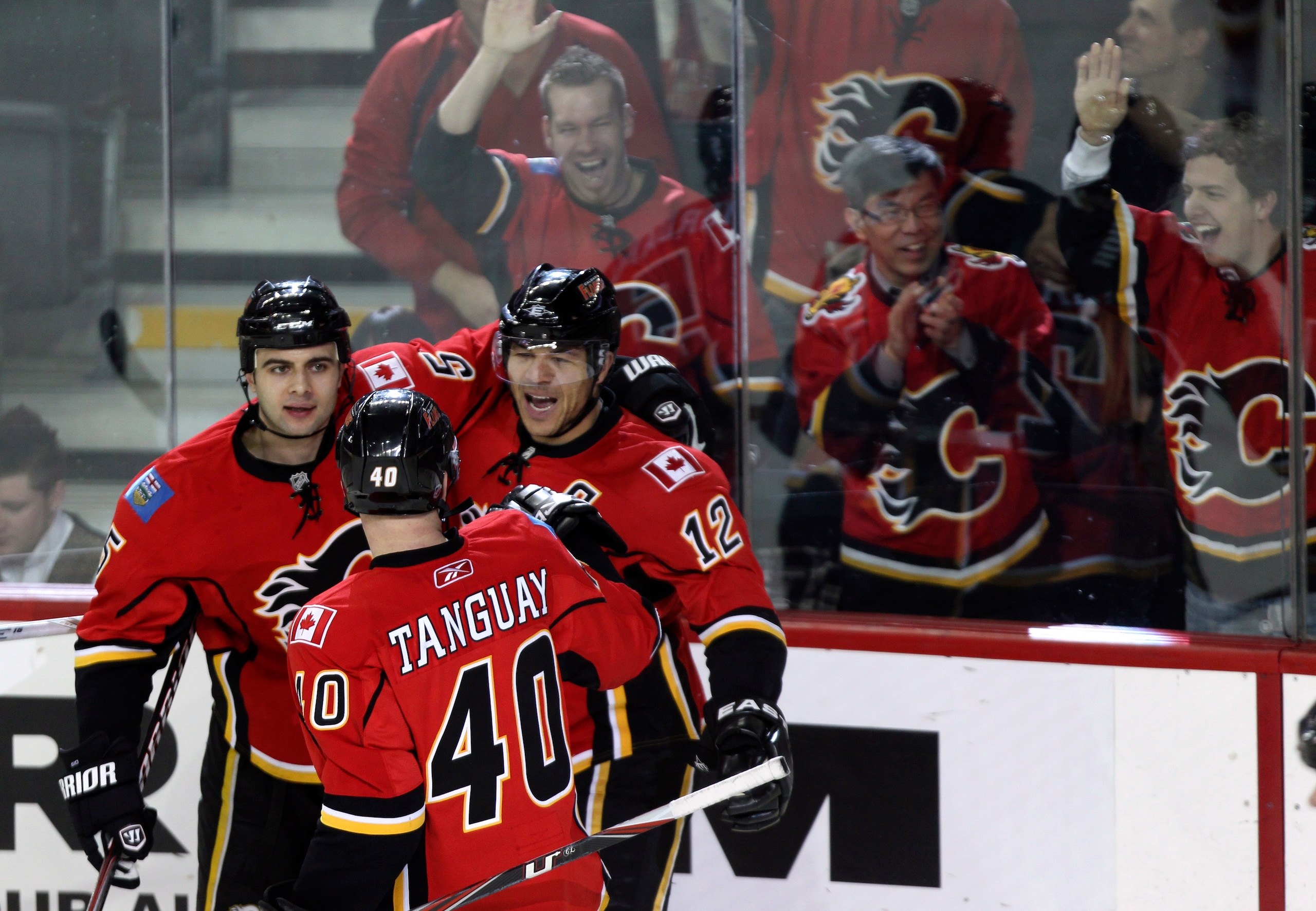 CALGARY, AB - MARCH 4: Jarome Iginla #12 of the Calgary Flames celebrates his goal with teammates Mark Giordano #5 and Alex Tanguay #40 against the Columbus Blue Jackets in the first period of NHL action on March 4, 2011 at the Scotiabank Saddledome in Ca