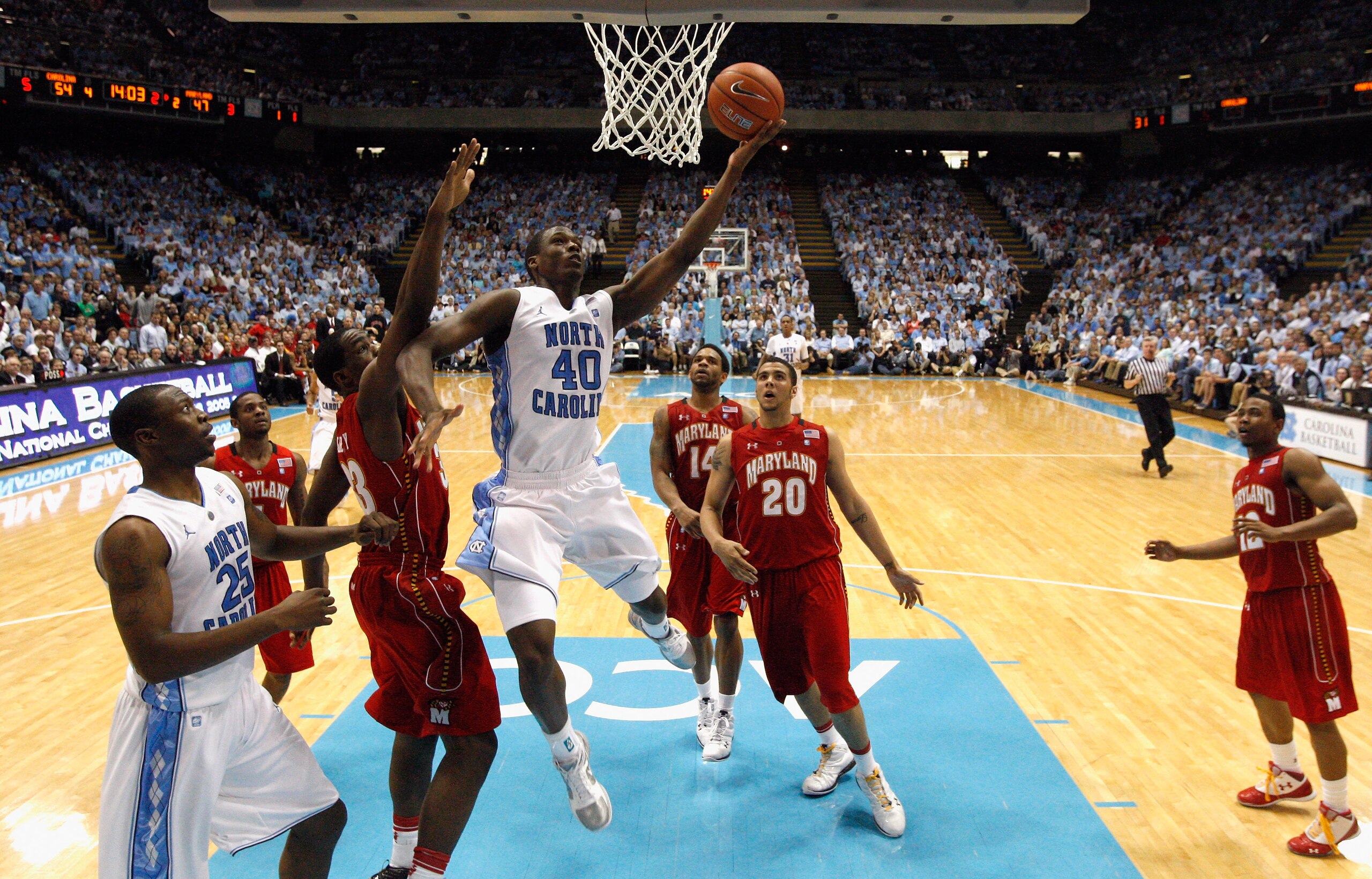 CHAPEL HILL, NC - FEBRUARY 27:  Harrison Barnes #40 of the North Carolina Tar Heels drives to the basket on Dino Gregory #33 of the Maryland Terrapins during their game at the Dean E. Smith Center on February 27, 2011 in Chapel Hill, North Carolina.  (Pho