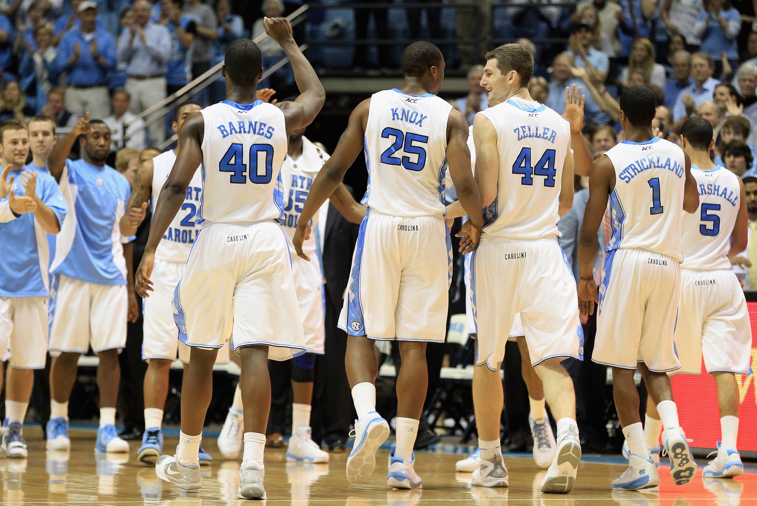 CHAPEL HILL, NC - FEBRUARY 27: Teammates Justin Knox #25 and Tyler Zeller #44 of the North Carolina Tar Heels celebrate with teammates as they walk back to the bench during their game against the Maryland Terrapins at the Dean E. Smith Center on February CHAPEL HILL, NC - FEBRUARY 27: Teammates Justin Knox #25 and Tyler Zeller #44 of the North Carolina Tar Heels celebrate with teammates as they walk back to the bench during their game against the Maryland Terrapins at the Dean E. Smith Center on February