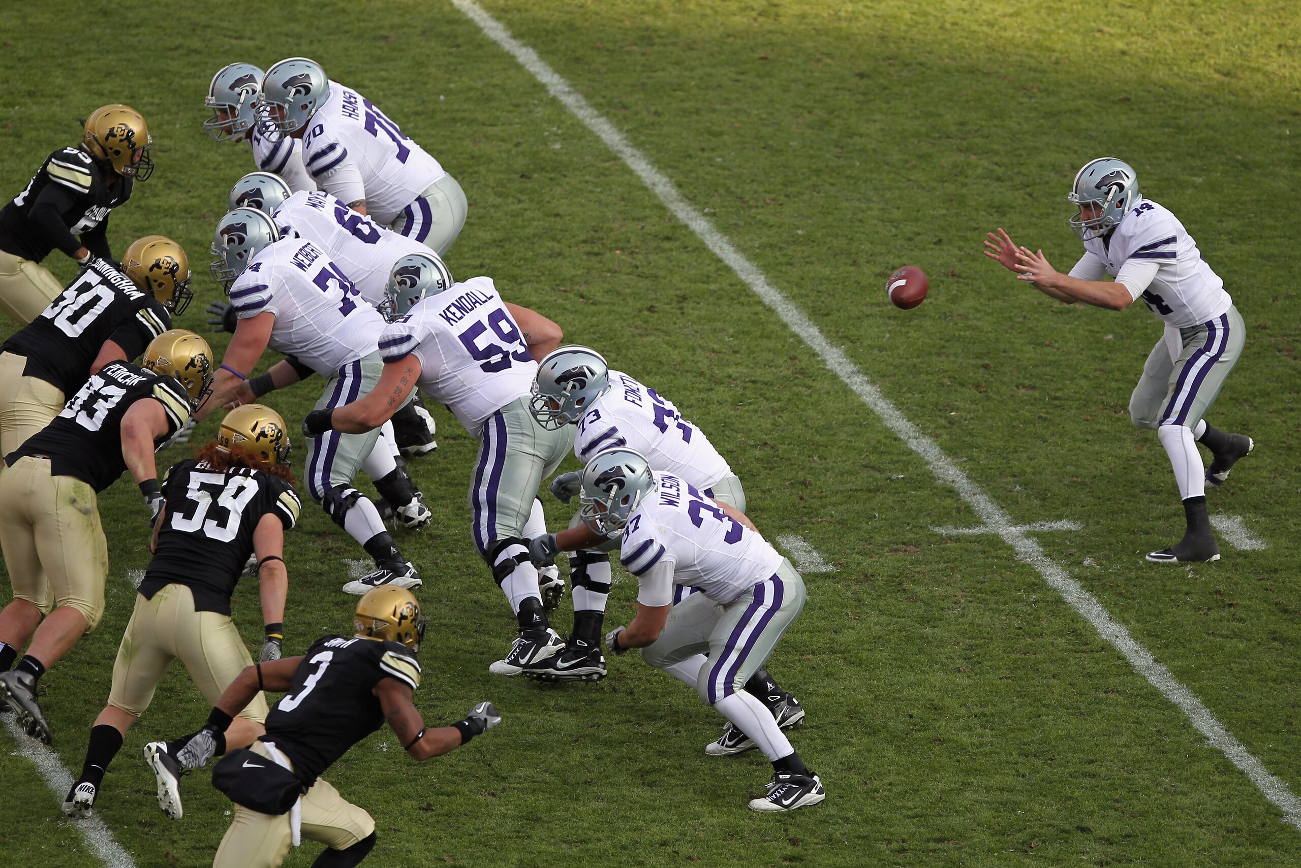 BOULDER, CO - NOVEMBER 20: Quarterback Carson Coffman #14 of the Kansas State Wildcats takes the snap against the Colorado Buffaloes defense at Folsom Field on November 20, 2010 in Boulder, Colorado. Colorado defeated Kansas State 44-36. (Photo by Doug BOULDER, CO - NOVEMBER 20: Quarterback Carson Coffman #14 of the Kansas State Wildcats takes the snap against the Colorado Buffaloes defense at Folsom Field on November 20, 2010 in Boulder, Colorado. Colorado defeated Kansas State 44-36. (Photo by Doug