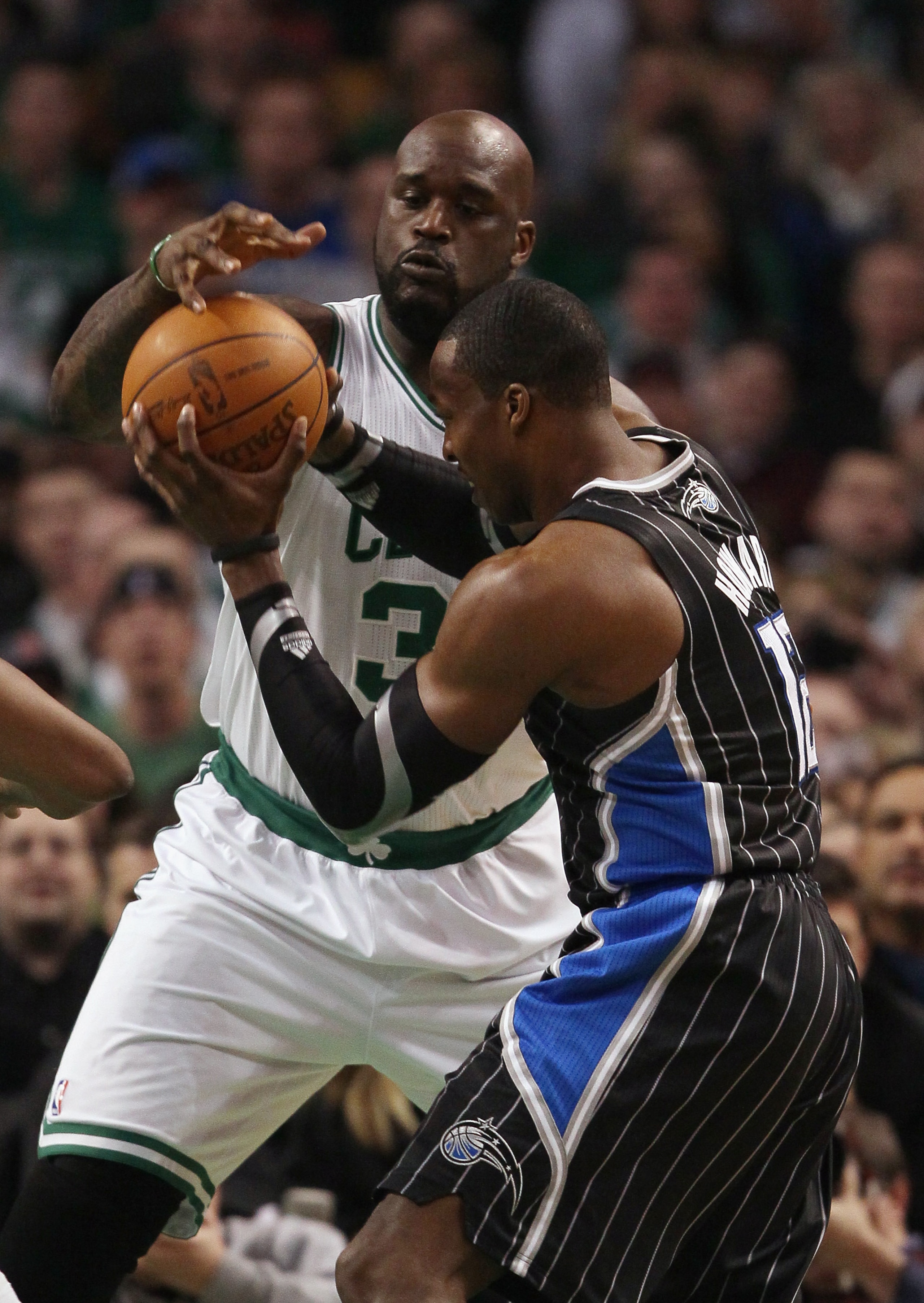 BOSTON, MA - JANUARY 17:  Shaquille O'Neal #36 of the Boston Celtics is called for a foul as Dwight Howard #12 of the Orlando Magic heads for the basket on January 17, 2011 at the TD Garden in Boston, Massachusetts.  NOTE TO USER: User expressly acknowled