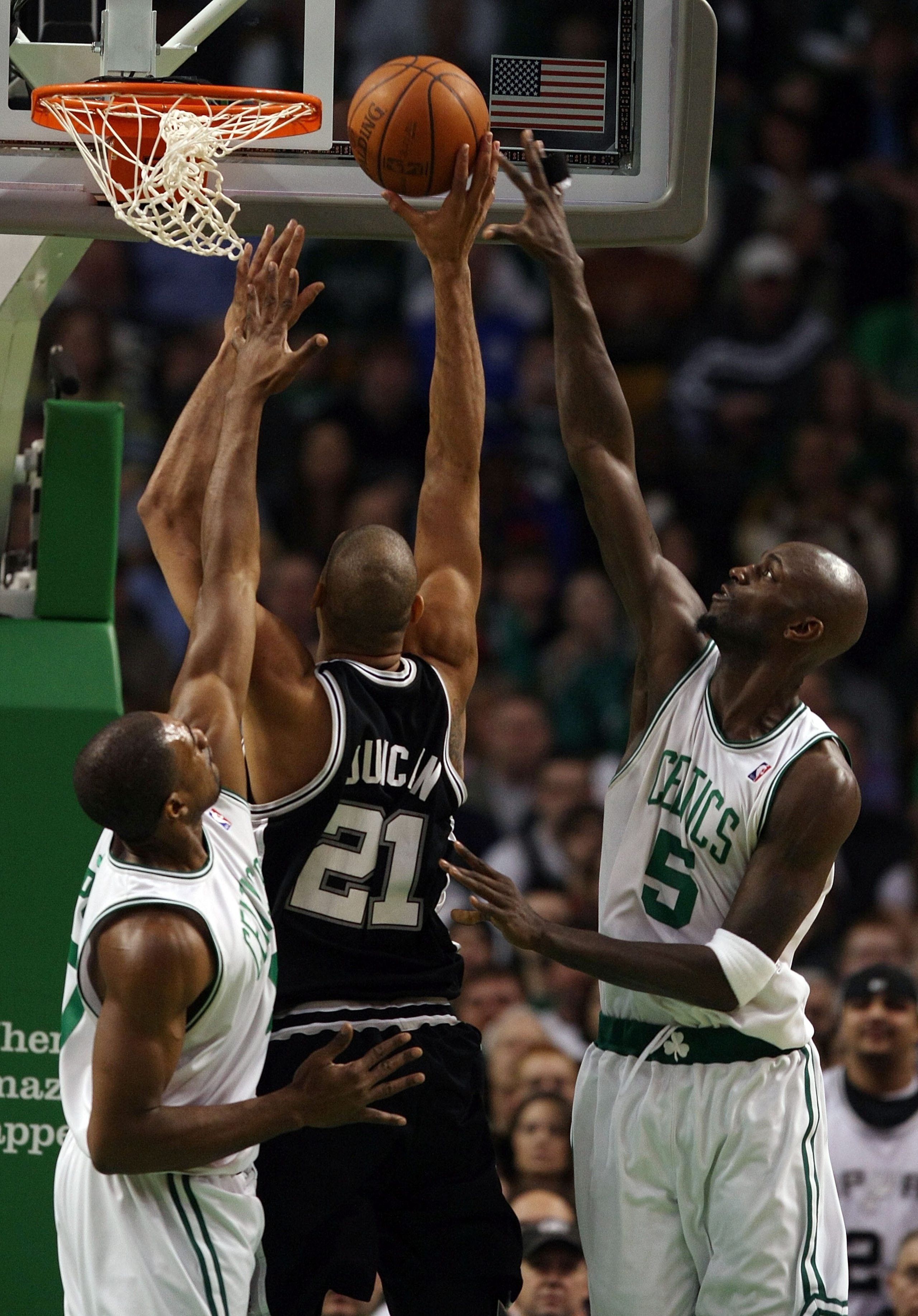 BOSTON - FEBRUARY 08:  Kevin Garnett #5 and Leon Powe #0 of the Boston Celtics try to block Tim Duncan #21 of the San Antonio Spurs on February 8, 2009 at TD Banknorth Garden in Boston, Massachusetts. NOTE TO USER: User expressly acknowledges and agrees t