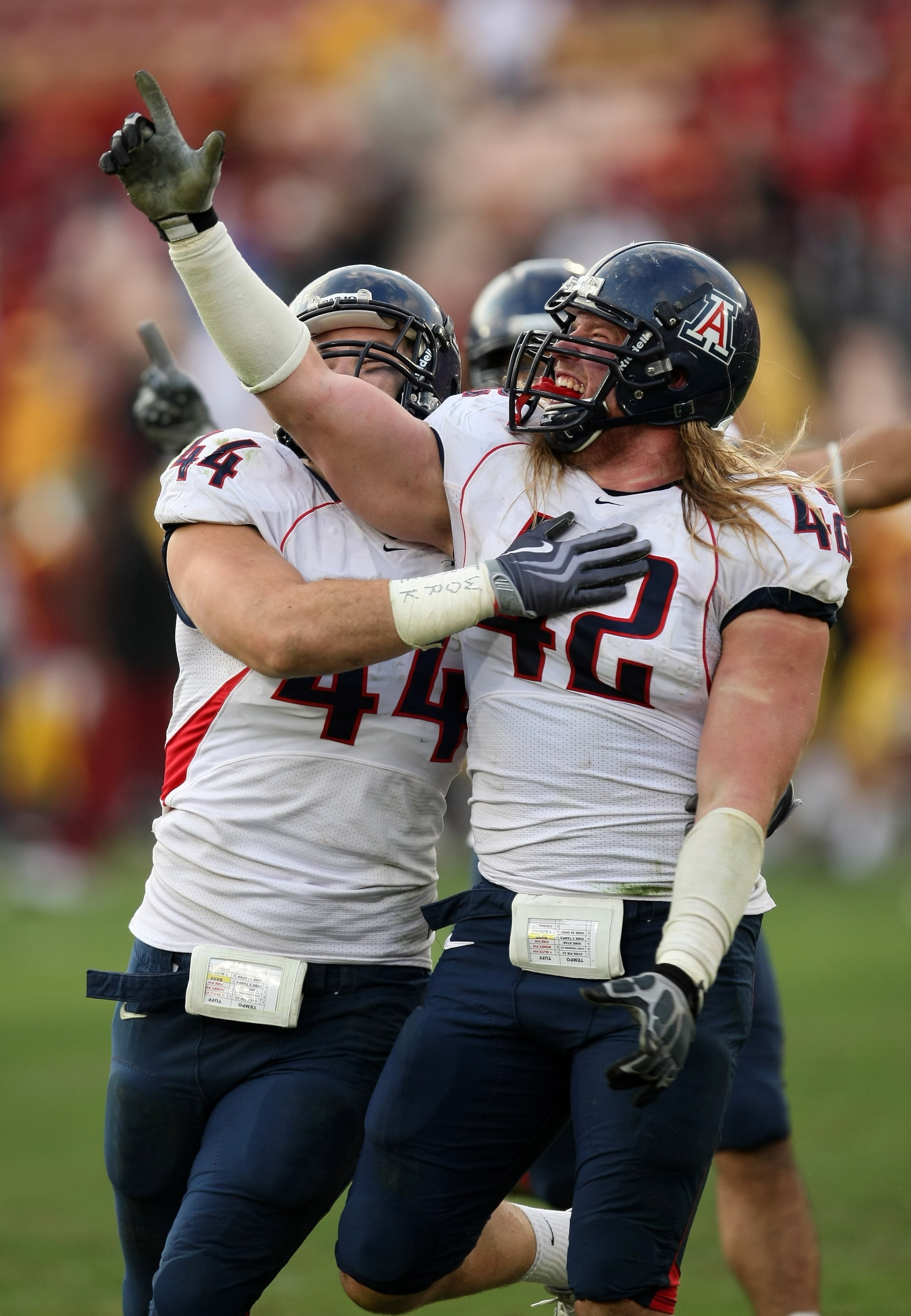 LOS ANGELES, CA - DECEMBER 05:  Defensive ends Brooks Reed #42 and Ricky Elmore #44 of the Arizona Wildcats celebrate after stopping the USC Trojans on the final play on December 5, 2009 at the Los Angeles Coliseum in Los Angeles, California. Arizona won