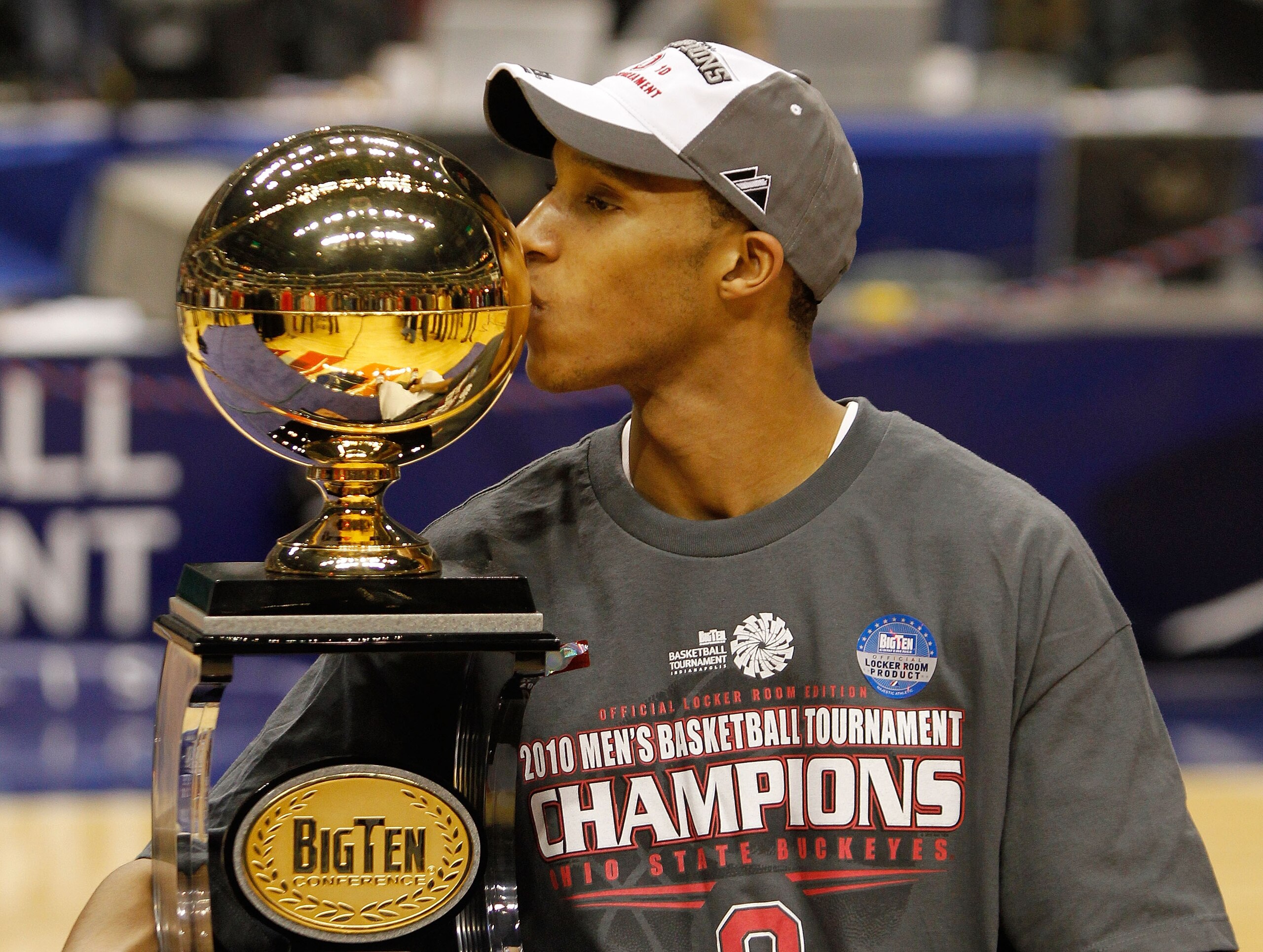 INDIANAPOLIS - MARCH 14:  Guard Evan Turner #21 of the Ohio State Buckeyes celebrates by kissing the Big Ten tournament championship trophy after winning the Big Ten Men's Basketball Tournament 90-61 over the Minnesota Golden Gophers at Conseco Fieldhouse