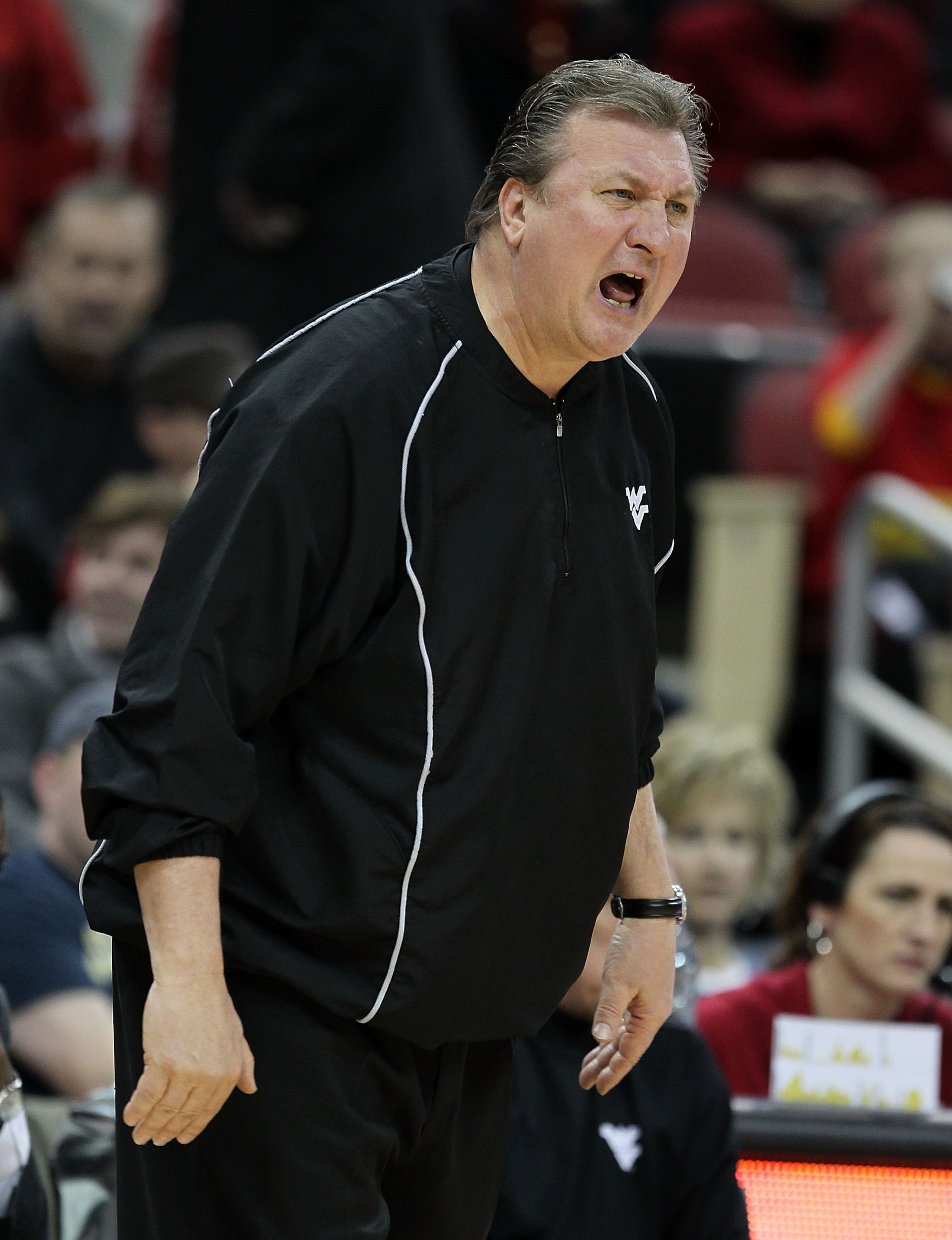 LOUISVILLE, KY - JANUARY 26: Bob Huggins the Head Coach of the West Virginia Mountaineers gives instructions to his team during the Big East Conference game against the Louisville Cardinals at the KFC Yum! Center on January 26, 2011 in Louisville, Kentuck