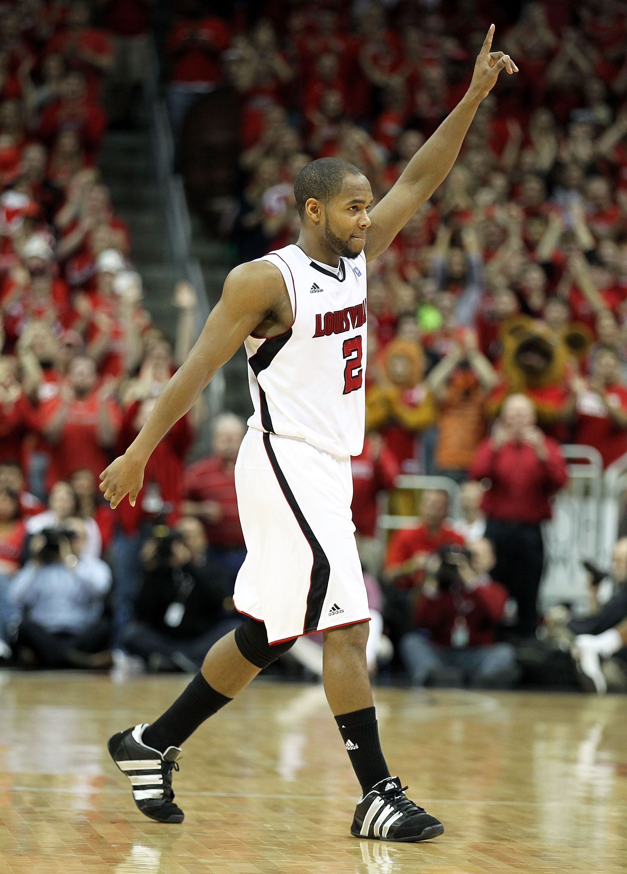LOUISVILLE, KY - MARCH 02:  Preston Knowles #2 of the Louisville Cardinals salutes the crowd as he leaves the game for good during the Big East Conference game against the Providence Friars at the KFC Yum! Center on March 2, 2011 in Louisville, Kentucky.