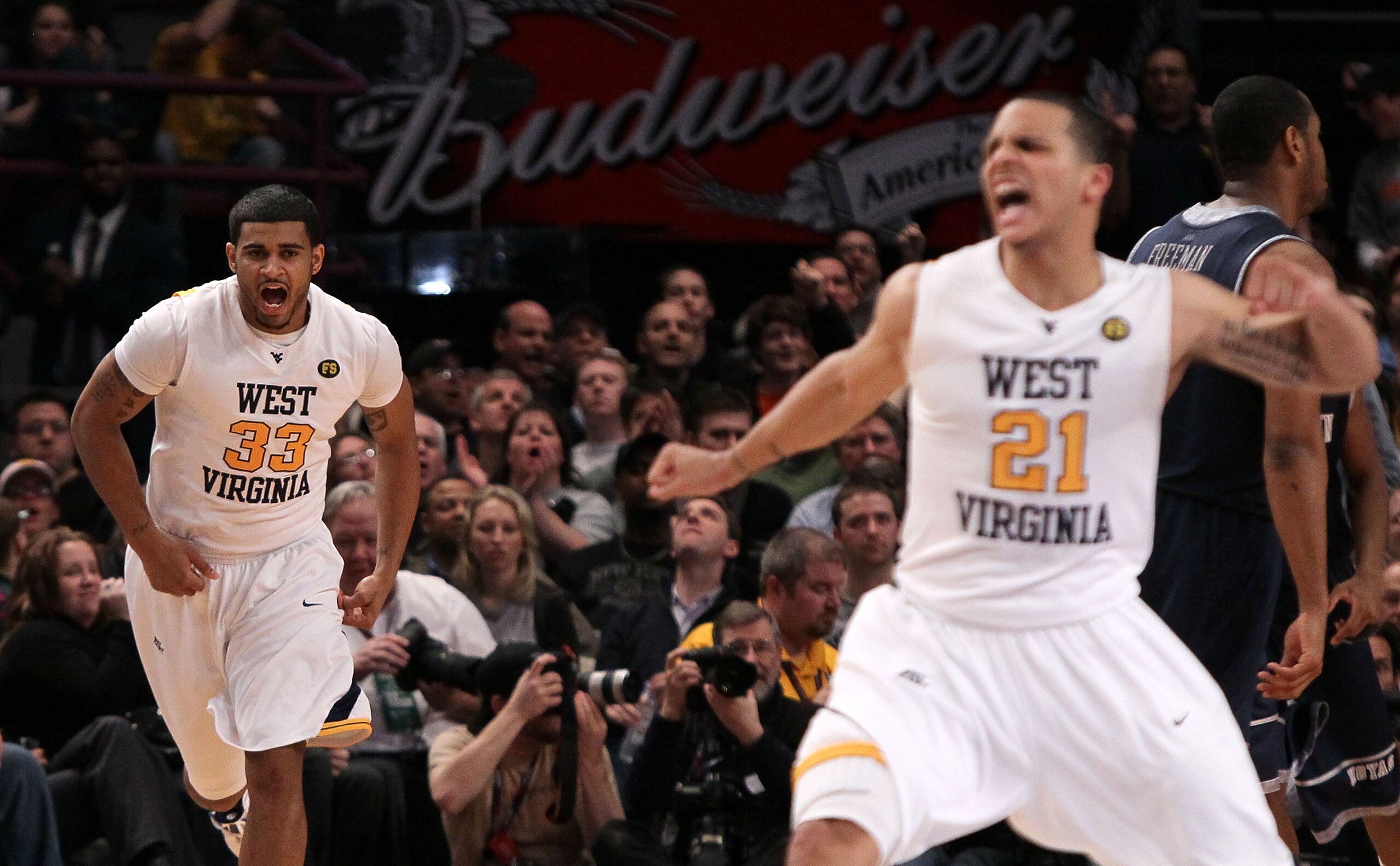 NEW YORK - MARCH 13: Casey Mitchell #33 and Joe Mazzulla #21 of the West Virginia Mountaineers celebrate after a play against the Georgetown Hoyas during the championship of the 2010 NCAA Big East Tournament at Madison Square Garden on March 13, 2010 in N