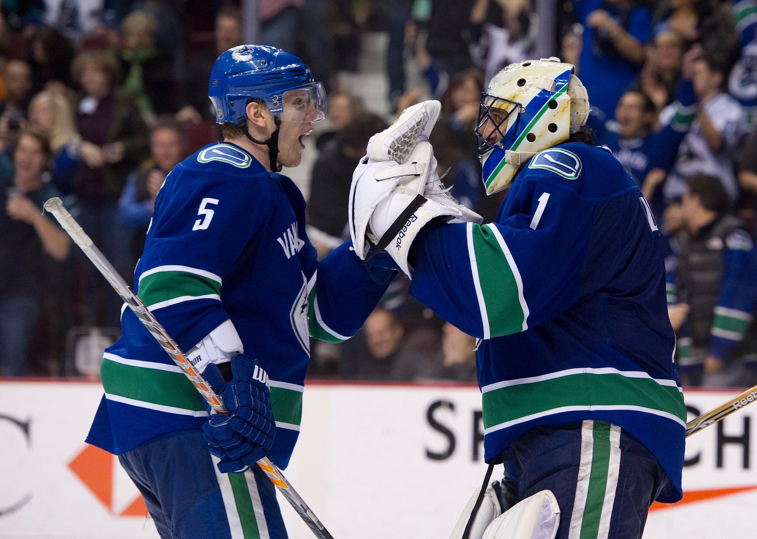 VANCOUVER, CANADA - FEBRUARY 4: Goalie Roberto Luongo #1 of the Vancouver Canucks celebrates with teammate Christian Ehrhoff #5 after defeating the Chicago Blackhawks in NHL action on February 04, 2011 at Rogers Arena in Vancouver, British Columbia, Canad