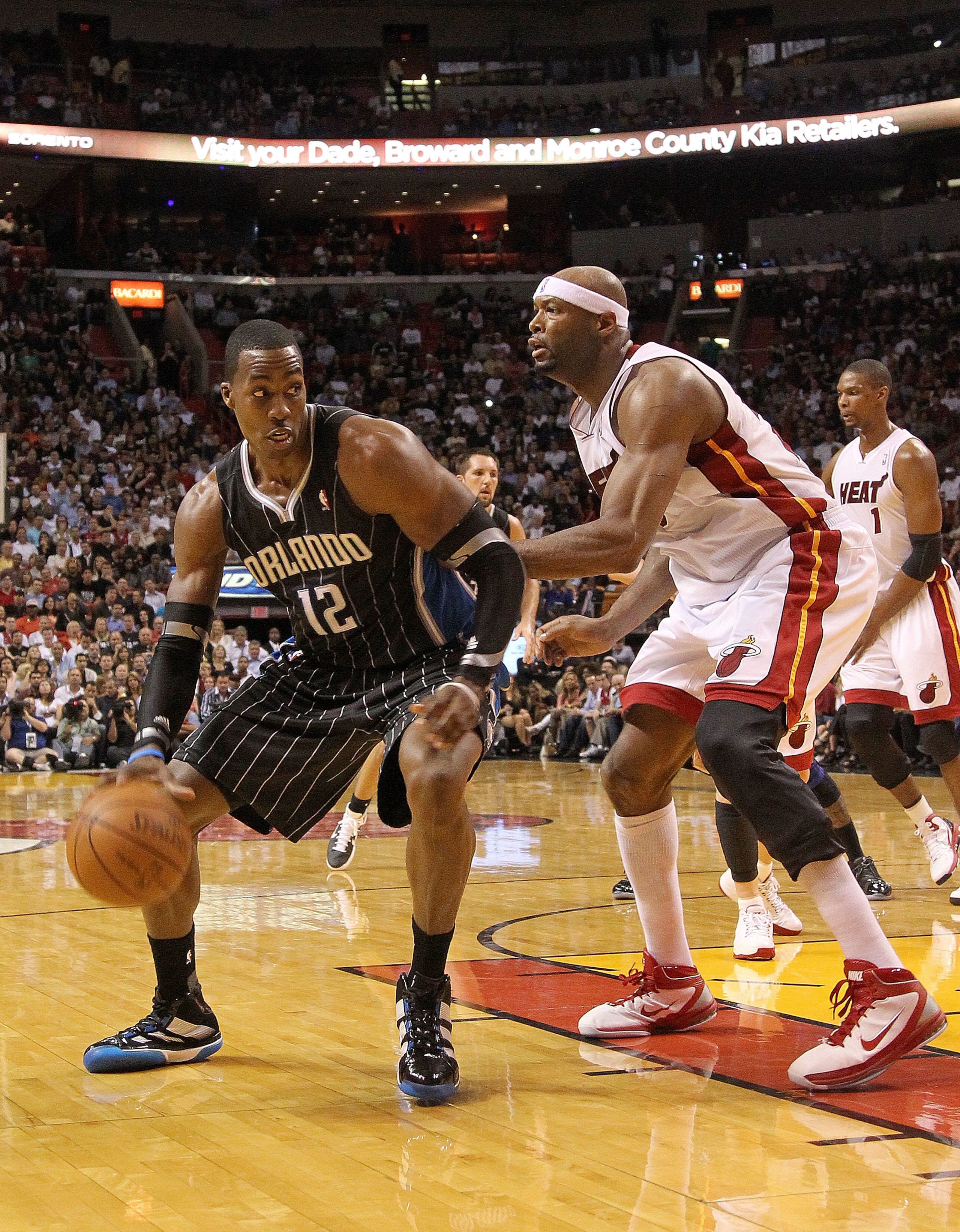 MIAMI, FL - MARCH 03: Dwight Howard #12 of the Orlando Magic drives against Eric Dampier #25 of the Miami Heat during a game at American Airlines Arena on March 3, 2011 in Miami, Florida. NOTE TO USER: User expressly acknowledges and agrees that, by down MIAMI, FL - MARCH 03: Dwight Howard #12 of the Orlando Magic drives against Eric Dampier #25 of the Miami Heat during a game at American Airlines Arena on March 3, 2011 in Miami, Florida. NOTE TO USER: User expressly acknowledges and agrees that, by down
