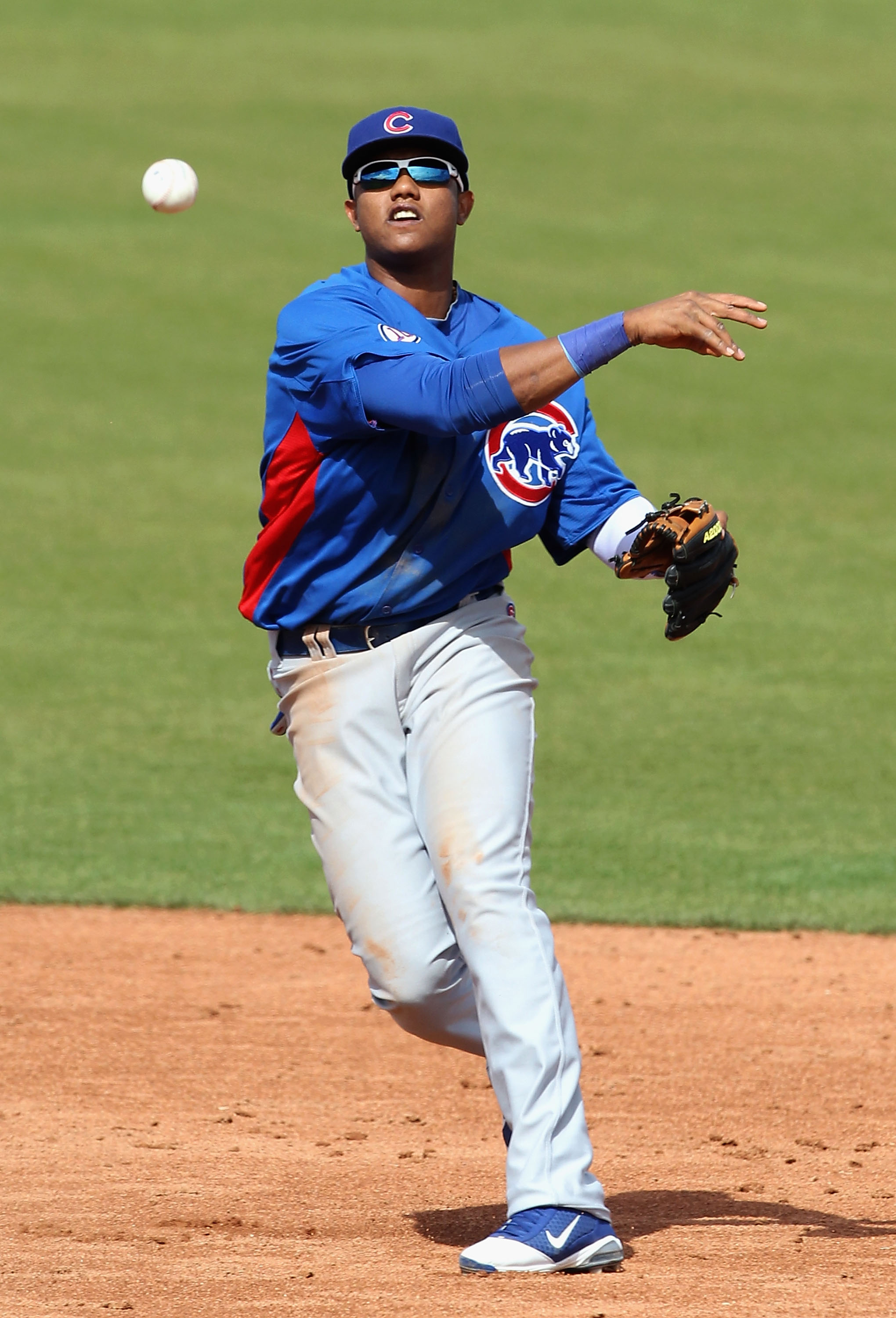 SCOTTSDALE, AZ - MARCH 01:  Infielder Starlin Castro #13 of the Chicago Cubs throws to first base attempting to turn a double play during the spring training game against the San Francisco Giants at Scottsdale Stadium on March 1, 2011 in Scottsdale, Arizo