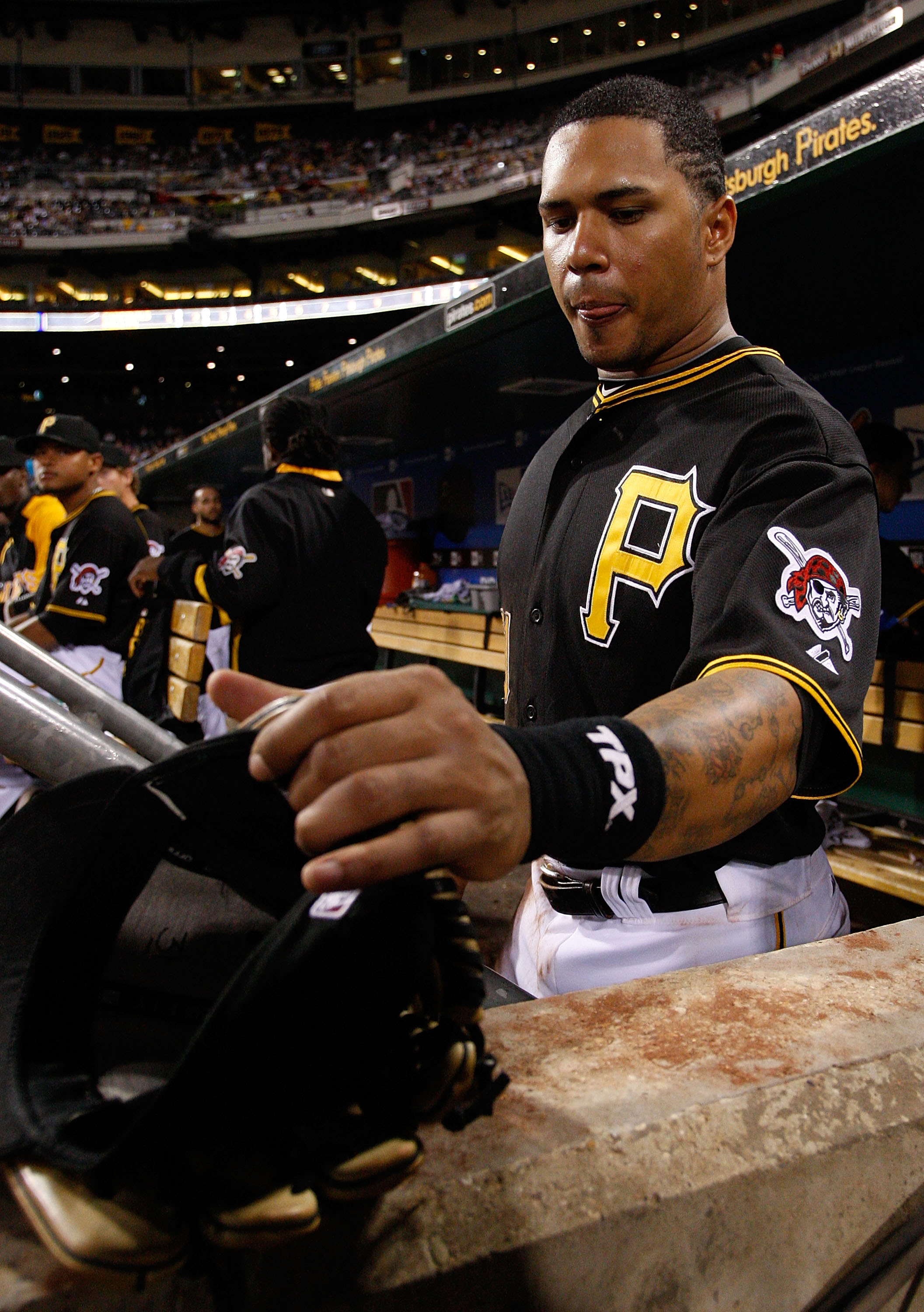 PITTSBURGH - SEPTEMBER 21:  Jose Tabata #31 of the Pittsburgh Pirates grabs his hat and glove before heading out onto the field during the game against the St. Louis Cardinals on September 21, 2010 at PNC Park in Pittsburgh, Pennsylvania.  (Photo by Jared