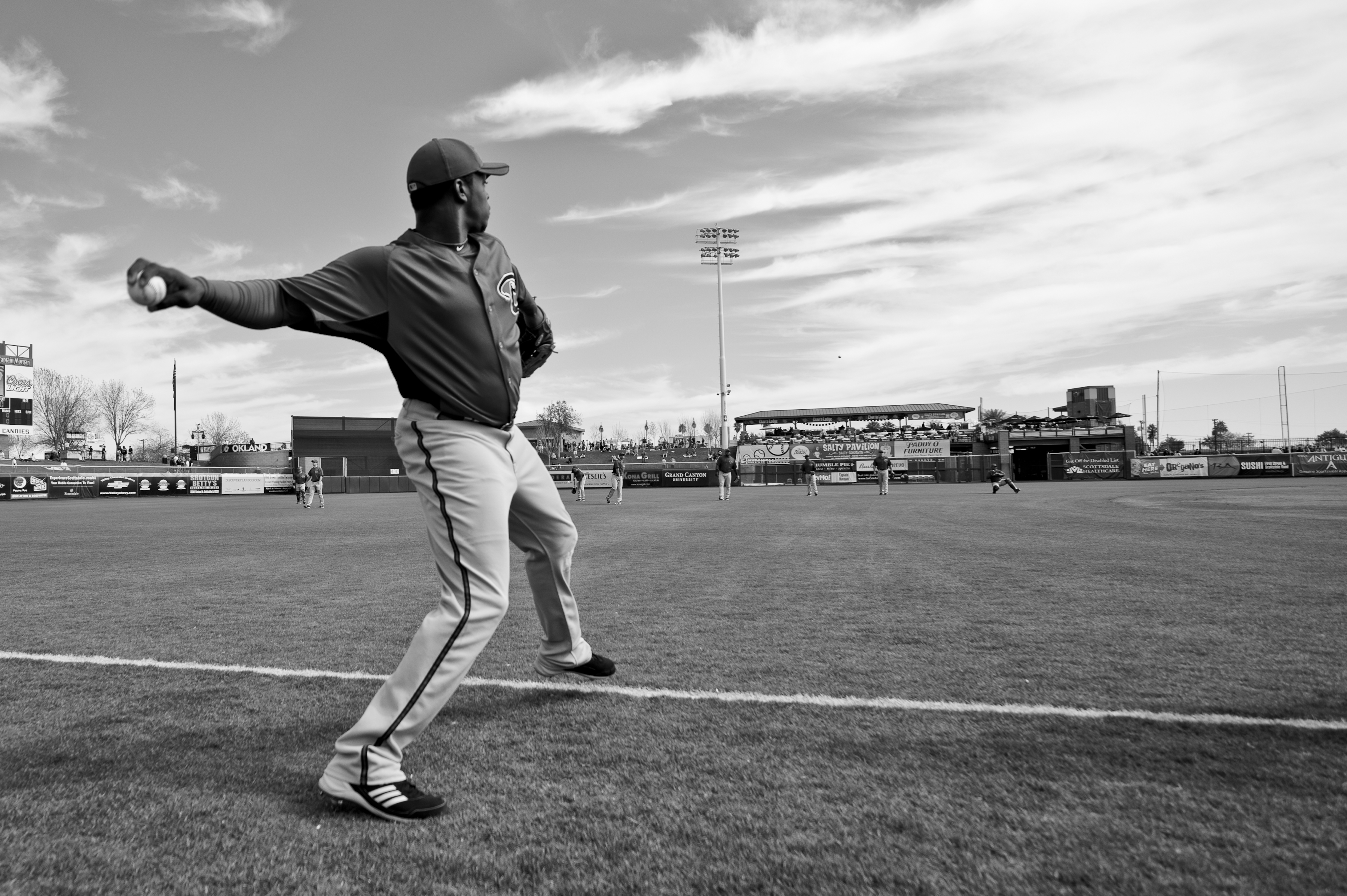 SCOTTSDALE, AZ - FEBRUARY 25: (EDITORS NOTE: Image has been converted to black and white.) )Justin Upton #10 of the Arizona Diamondbacks warms up throwing before a spring training game San Francisco Giant at Scottsdale Stadium on February 25, 2011 in Scot