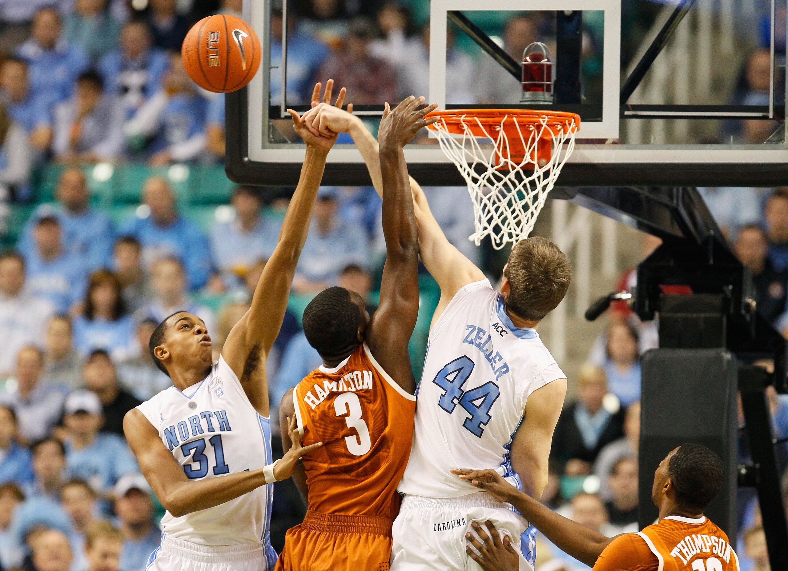 GREENSBORO, NC - DECEMBER 18: Tyler Zeller #44 and John Henson #31 of the North Carolina Tar Heels block a shot by Jordan Hamilton #3 of the Texas Longhorns at Greensboro Coliseum on December 18, 2010 in Greensboro, North Carolina. (Photo by Kevin C. Co GREENSBORO, NC - DECEMBER 18: Tyler Zeller #44 and John Henson #31 of the North Carolina Tar Heels block a shot by Jordan Hamilton #3 of the Texas Longhorns at Greensboro Coliseum on December 18, 2010 in Greensboro, North Carolina. (Photo by Kevin C. Co