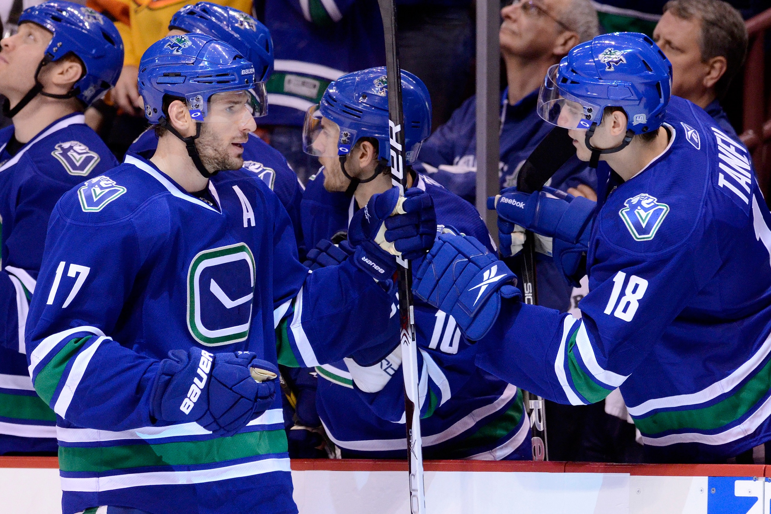 VANCOUVER, CANADA - JANUARY 22: Ryan Kesler #17 of the Vancouver Canucks is congratulated by teammate Chris Tanev #18 after scoring against the Calgary Flames during the third period in NHL action on January 22, 2011 at Rogers Arena in Vancouver, BC, Cana