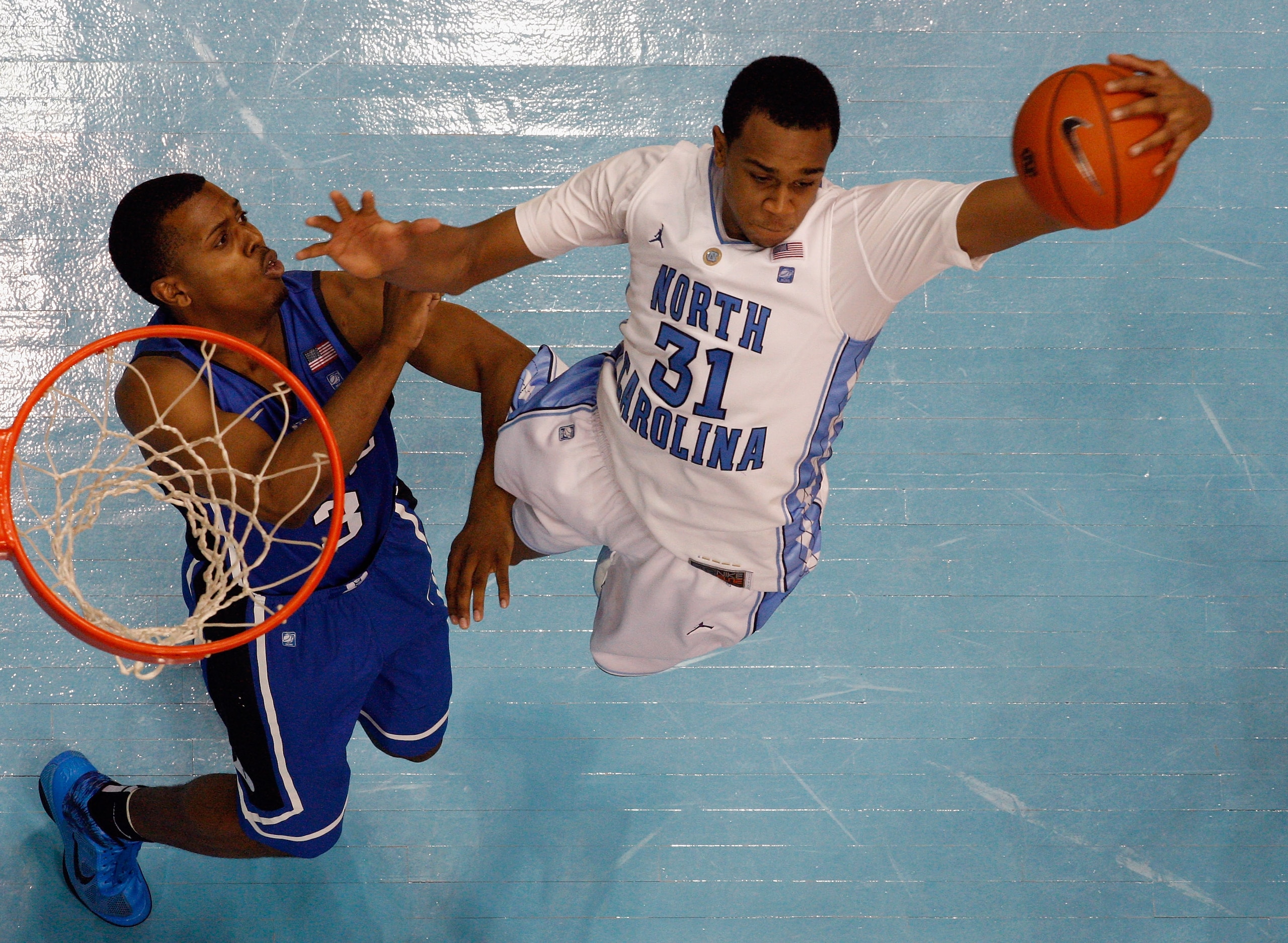 CHAPEL HILL, NC - MARCH 05:  Tyler Thornton #3 of the Duke Blue Devils goes after a rebound with John Henson #31 of the North Carolina Tar Heels during their game at the Dean E. Smith Center on March 5, 2011 in Chapel Hill, North Carolina.  (Photo by Stre