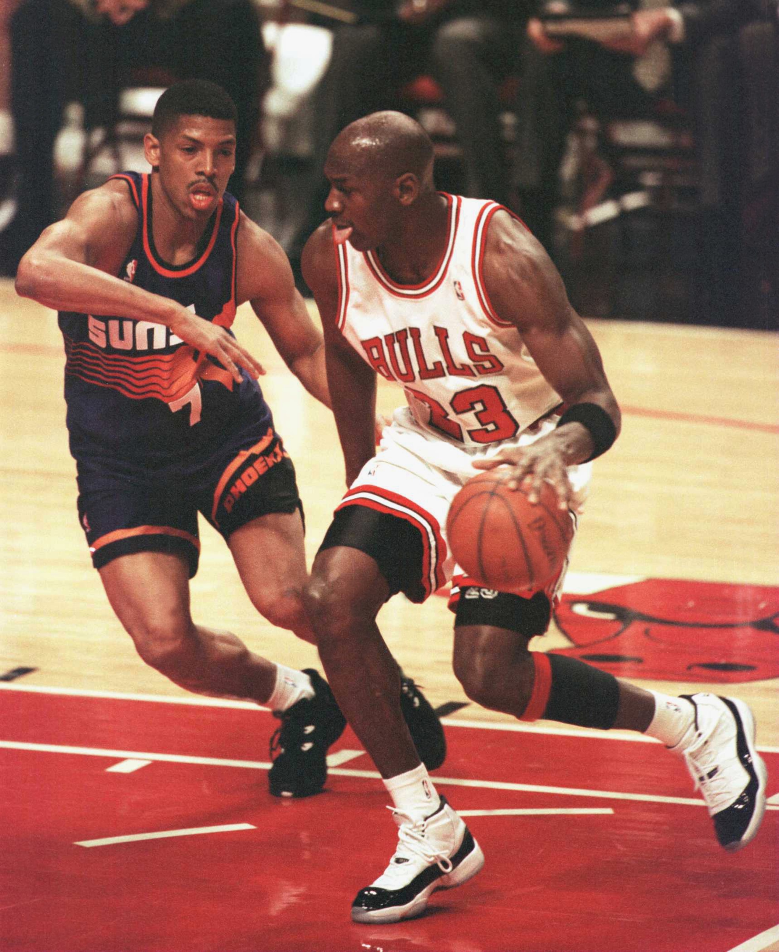 28 Jan 1996:  Forward Michael Jordan of the Chicago Bulls drives the lane past guard Kevin Johnson of the Phoenix Suns during first half action of the game at the United Center in Chicago, Illinois. The Bulls went on to beat the Suns 93-82, extending thei