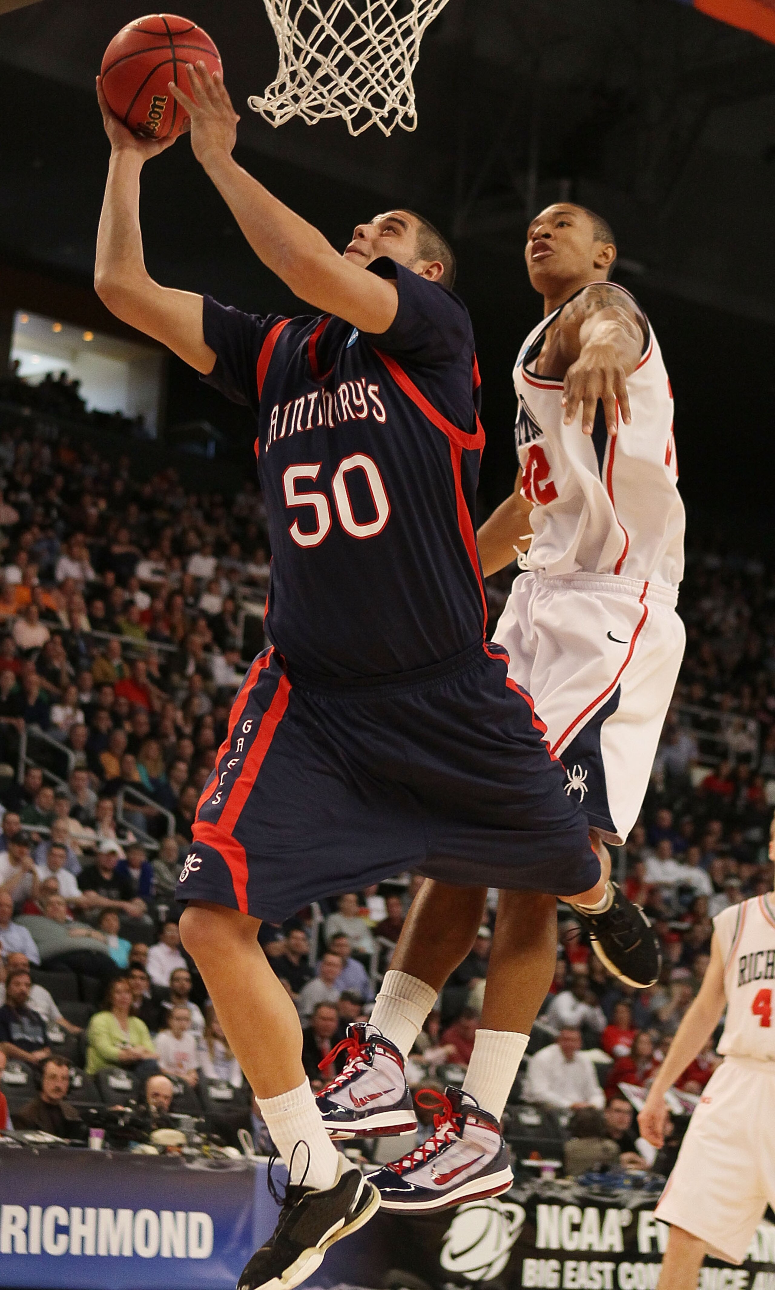 PROVIDENCE, RI - MARCH 18:  Omar Samhan #50 of the Saint Mary's Gaels takese a shot as Justin Harper #32 of the Richmond Spiders defends during the first round of the 2010 NCAA men's basketball tournament on March 18, 2010 at the Dunkin Donuts Arena in Pr