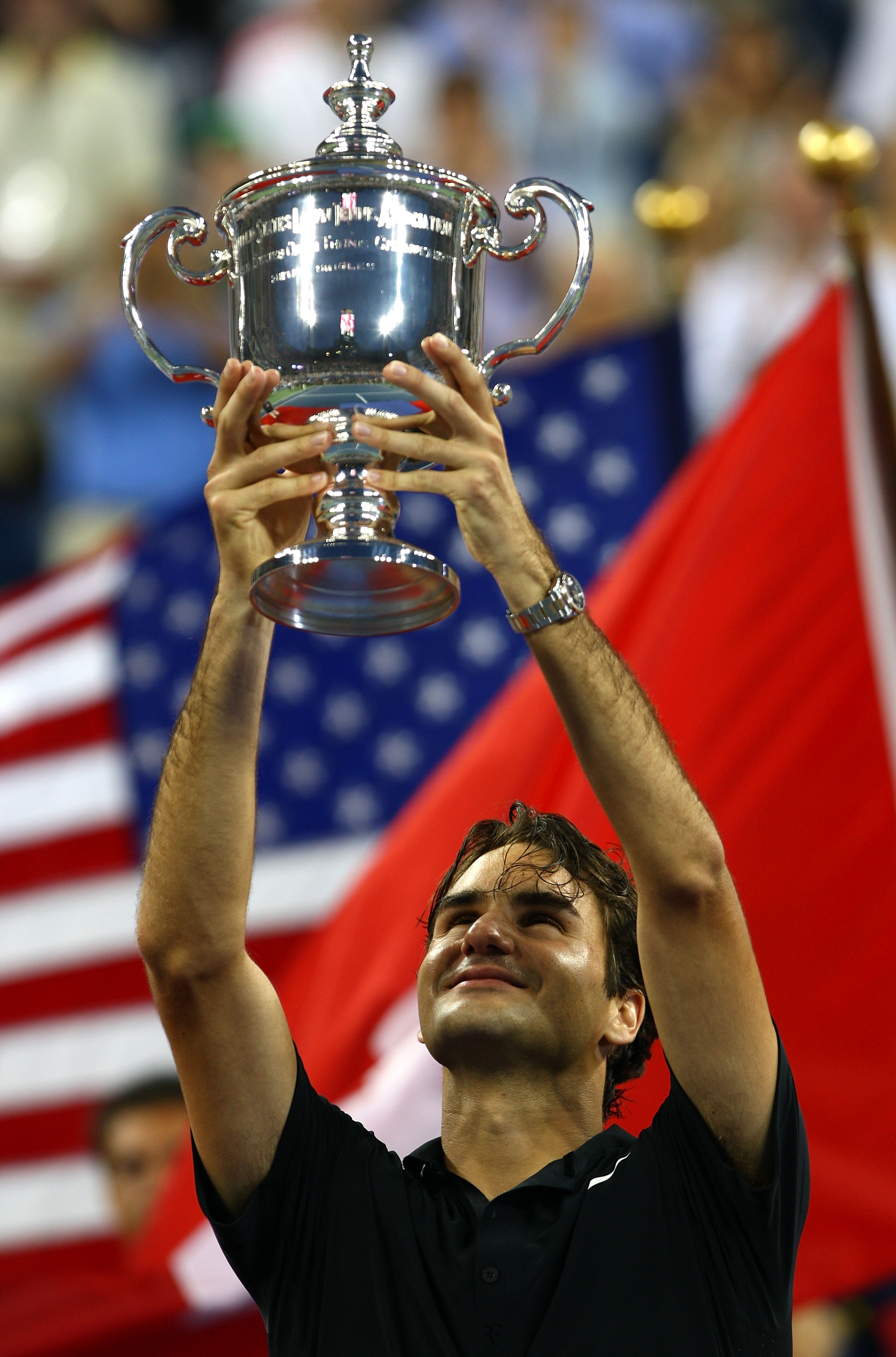 NEW YORK - SEPTEMBER 09:  Roger Federer of Switzerland celebrates with the trophy after defeating Novak Djokovic of Serbia by a score of 7-6(4), 7-6(2), 6-4 to win the Men's Singles Final on day fourteen of the 2007 U.S. Open in Arthur Ashe Stadium at the