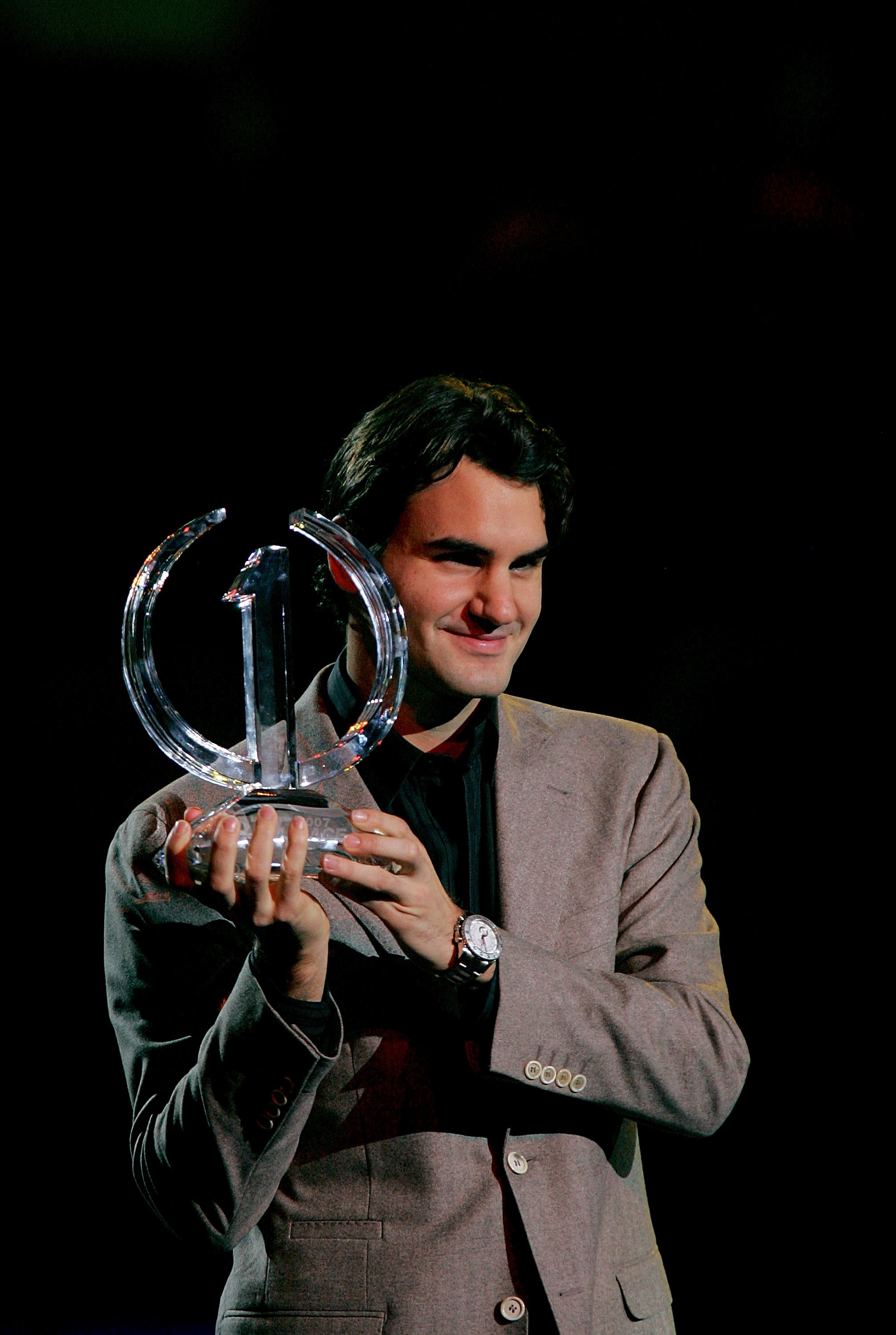 SHANGHAI, CHINA - NOVEMBER 13:  Roger Federer of Switzerland receives the ATP Race 2007 Trophy for finishing the regular season number one on November 13, 2007 during the Tennis Masters Cup at Qi Zhong Stadium in Shanghai, China.  (Photo by Matthew Stockm
