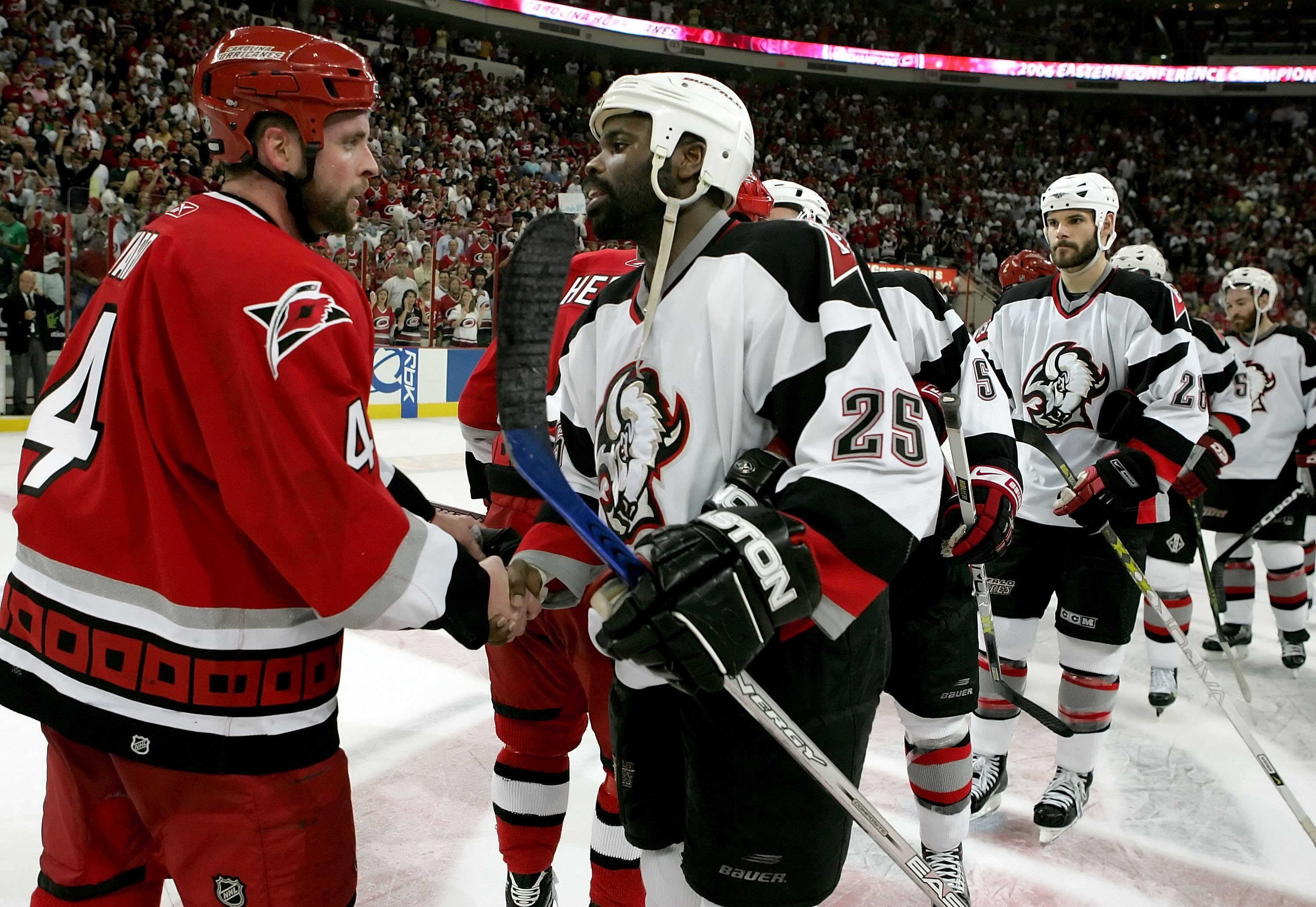 RALEIGH, NC - JUNE 01:  Aaron Ward #4 of the Carolina Hurricanes is congratulated by Mike Grier #25 of the Buffalo Sabres after the Hurricanes clinched the Eastern Conference Championship by defeating the Sabre 4-2 in game seven of the 2006 NHL Playoffs o